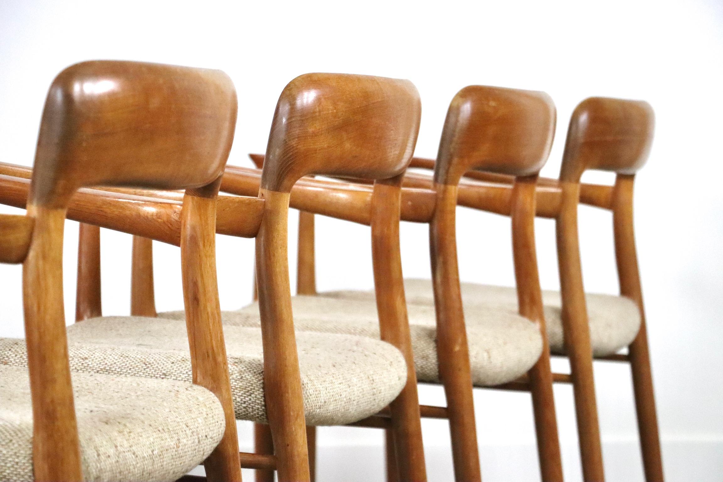 Incredible set of 4 Model 56 oak dining chairs with sculpted arm rests designed in the 1950s by Niels Otto Møller for J.L. Møller. Beautiful oak frame which complements the beige/ cream wool upholstery on the seatings. A sophisticated set to elevate