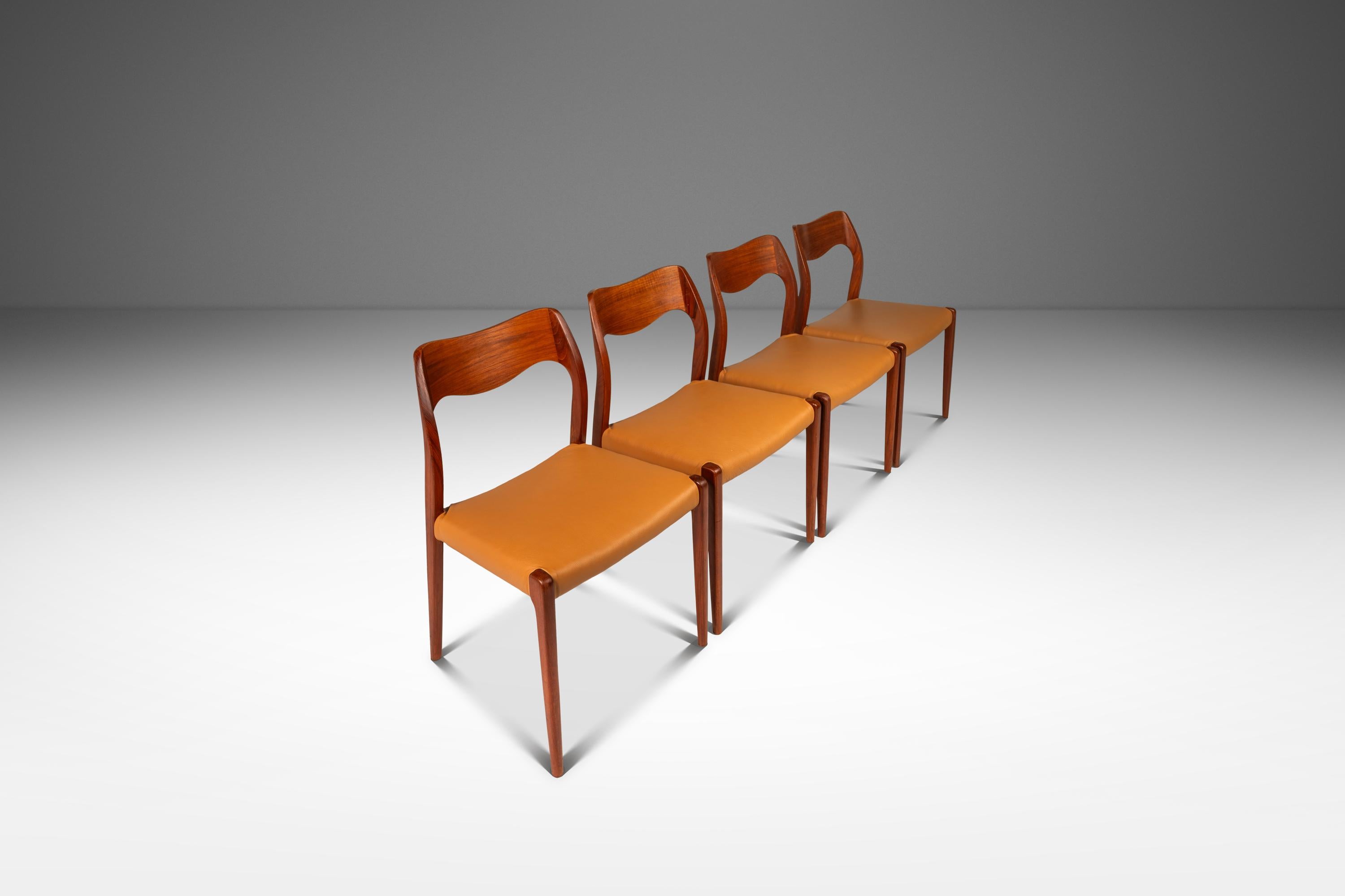 This distinguished set of four Model #71 dining chairs, designed by Niels Otto Møller for J.L. Møllers Møbelfabrik in 1951, exemplifies the elegance and craftsmanship of Danish modern design. Each chair features a solid teak frame with gracefully