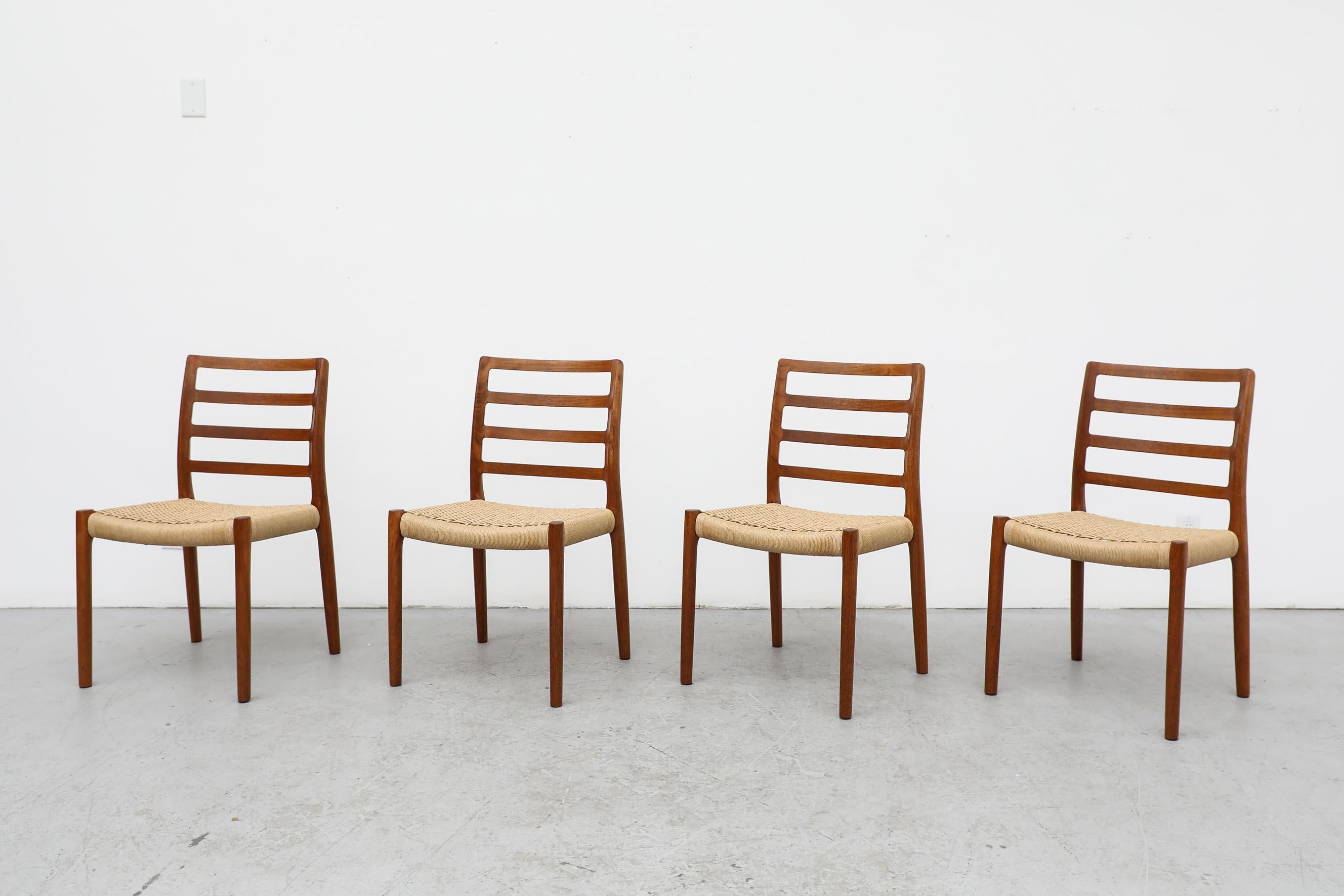 Set of 4 Classic Mid-Century teak ladder back and paper cord dining chairs designed by Niels Moller for J.L.Moller. In original condition with normal signs of wear consistent with their age and use.