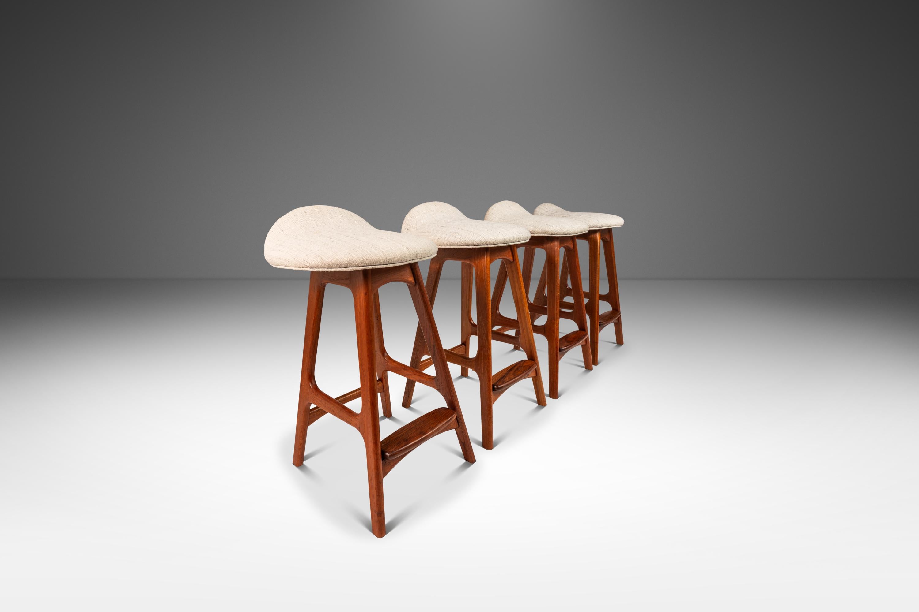 Introducing a limited set of four Model OD-61 counter-height barstools designed by the influential Erik Buch for the lauded Odense Møbelfabrik. With legs and frames constructed from solid slabs of Burmese teak, replete with outstanding old-growth