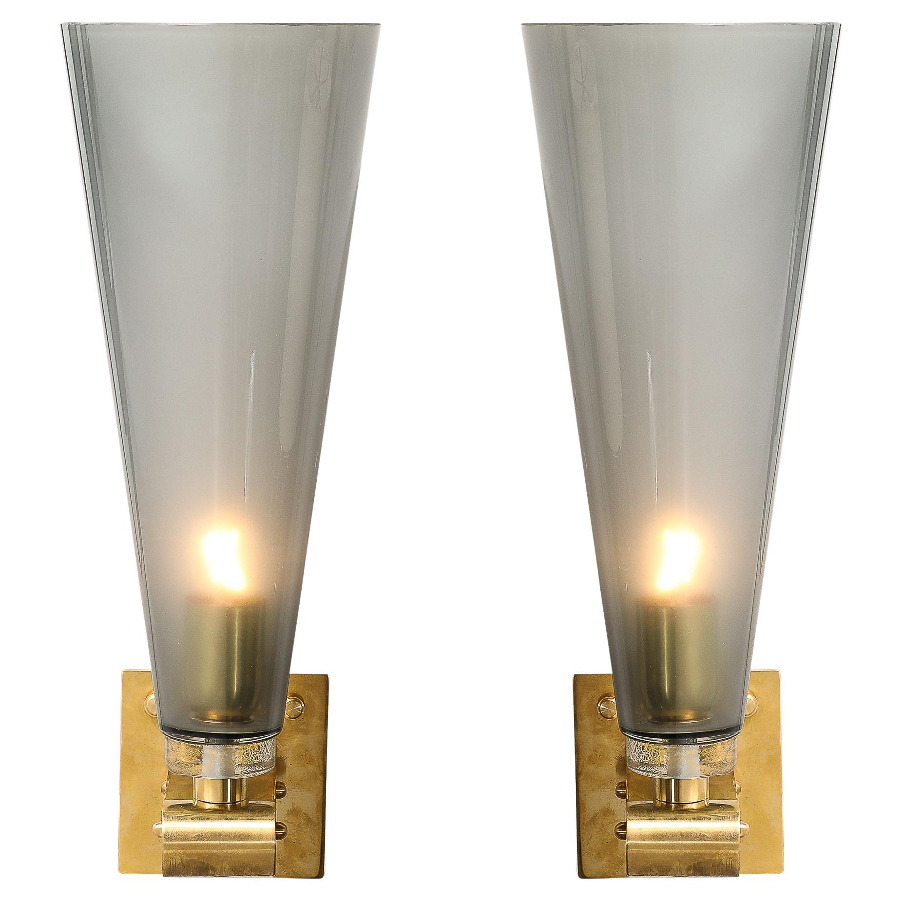 These beautifully composed and materially distinct Modernist Conical Hand-Blown Murano Glass Sconces in Smoked Graphite W/ Brass Fittings originate from Italy during the 21st Century. Featuring vertically oriented conical shade formed in Hand-Blown
