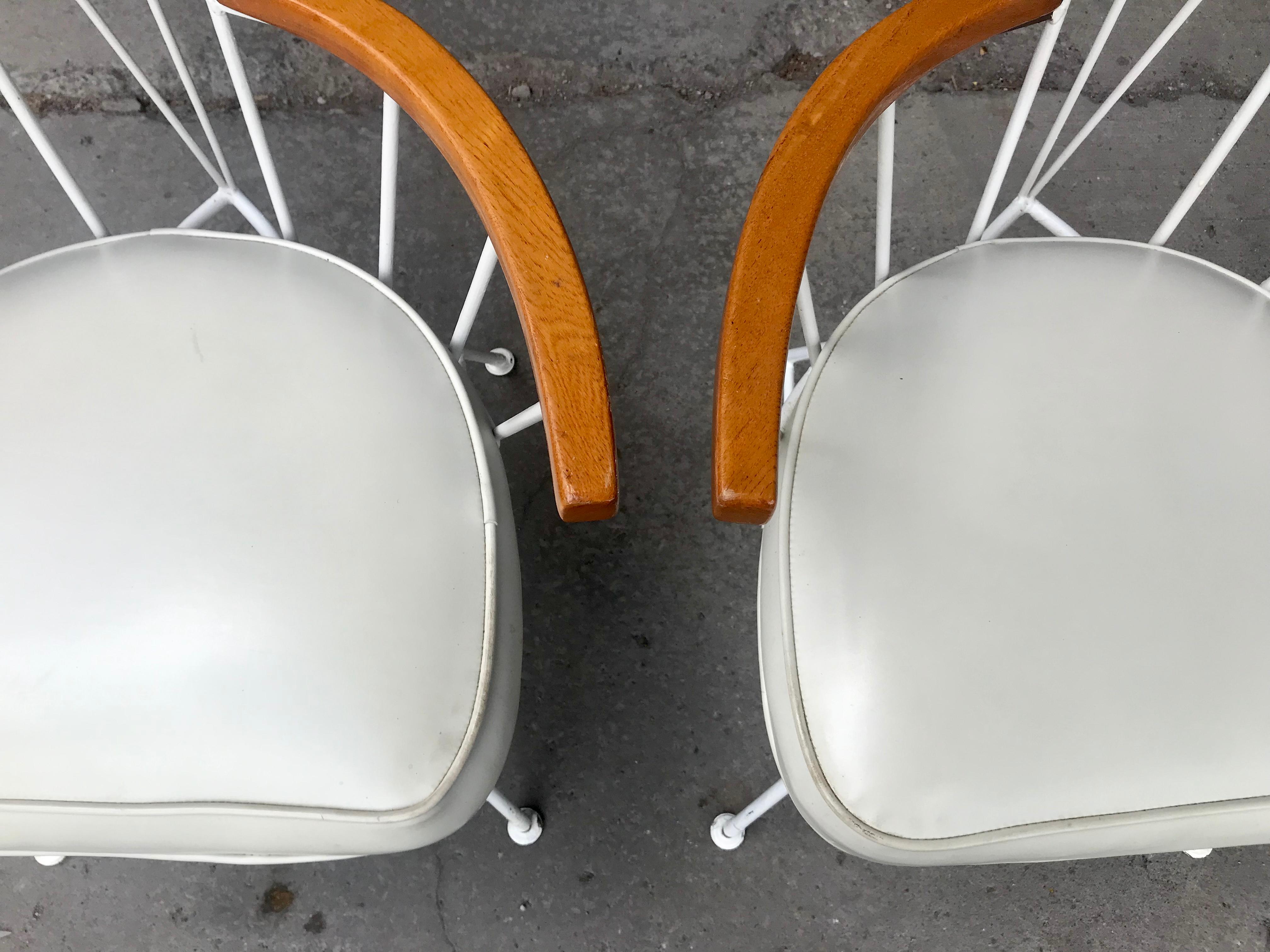 Set of 4 Modernist Iron and wood armchairs designed by Richard McCarthy, beautifully restored frames, retain they're original white Naugahyde seats, Classic Mid-Century Modern design, often attributed to Paul McCobb, Extremely comfortable,