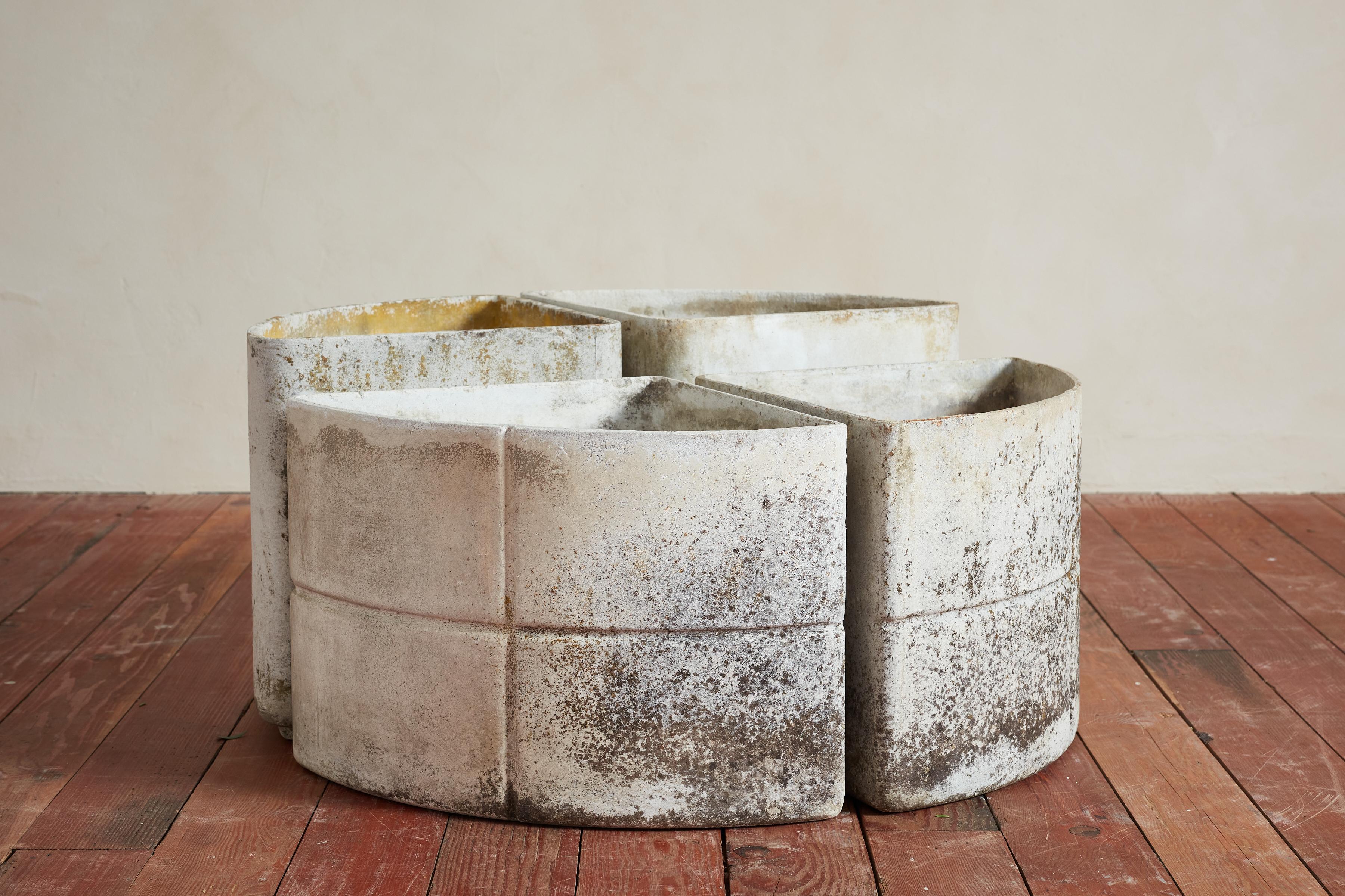 Concrete set of 4 triangular planters that together form a round shape - 
2 taller planters with cross shaped pattern on front the front 2 
Great patina sculptural garden object 

Priced as a set of 4 

Taller Piece: 16 1/2 x 15 1/2 x 15 in.