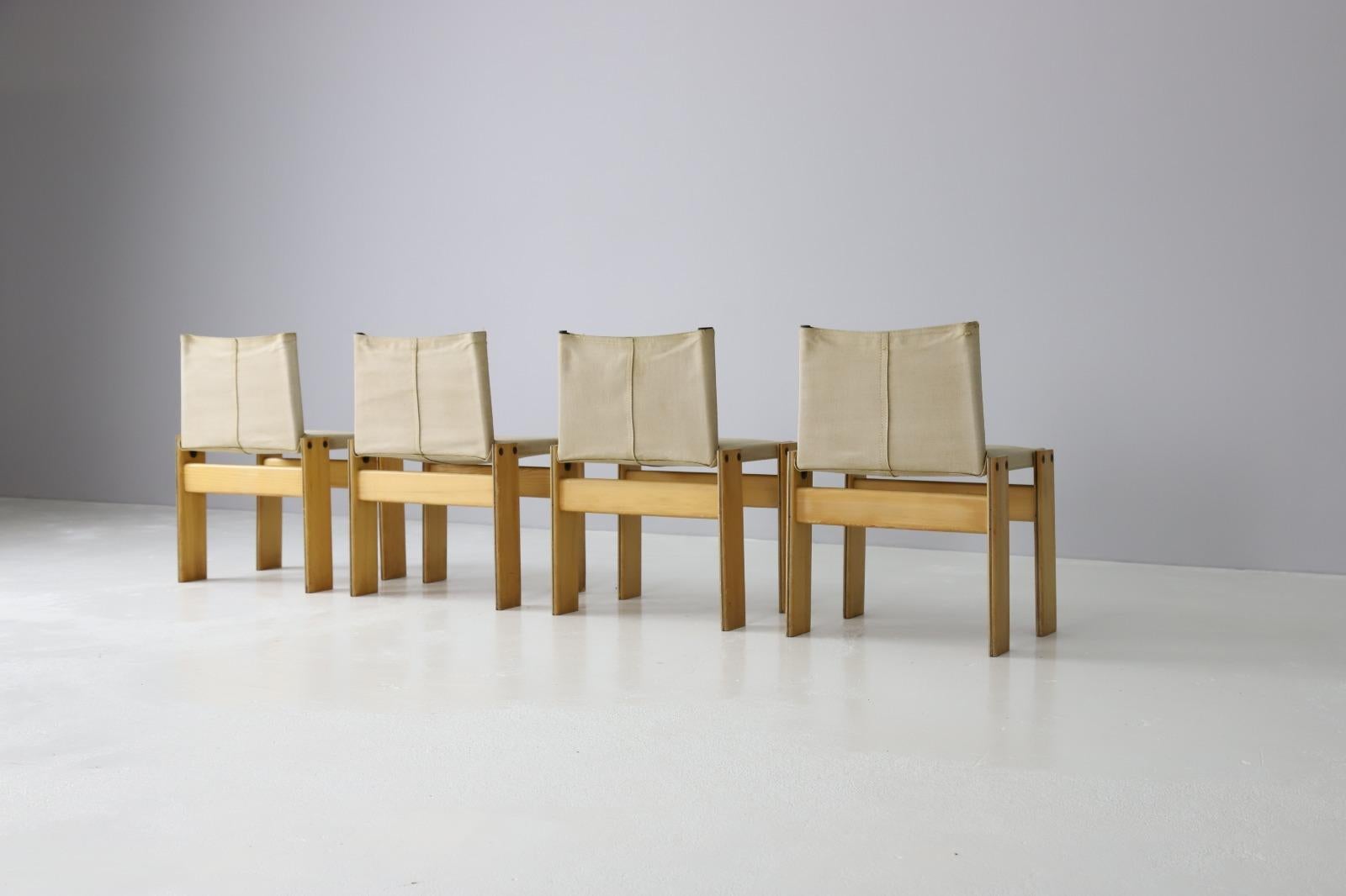 Set of 4 iconic 'Monk' chairs designed by Afra & Tobia Scarpa. Produced by Molteni in Italy 1974. The chairs feature original canvas upholstery and a pine wooden frame with dark wood inlay. One of the chairs has a damage on the top right corner.