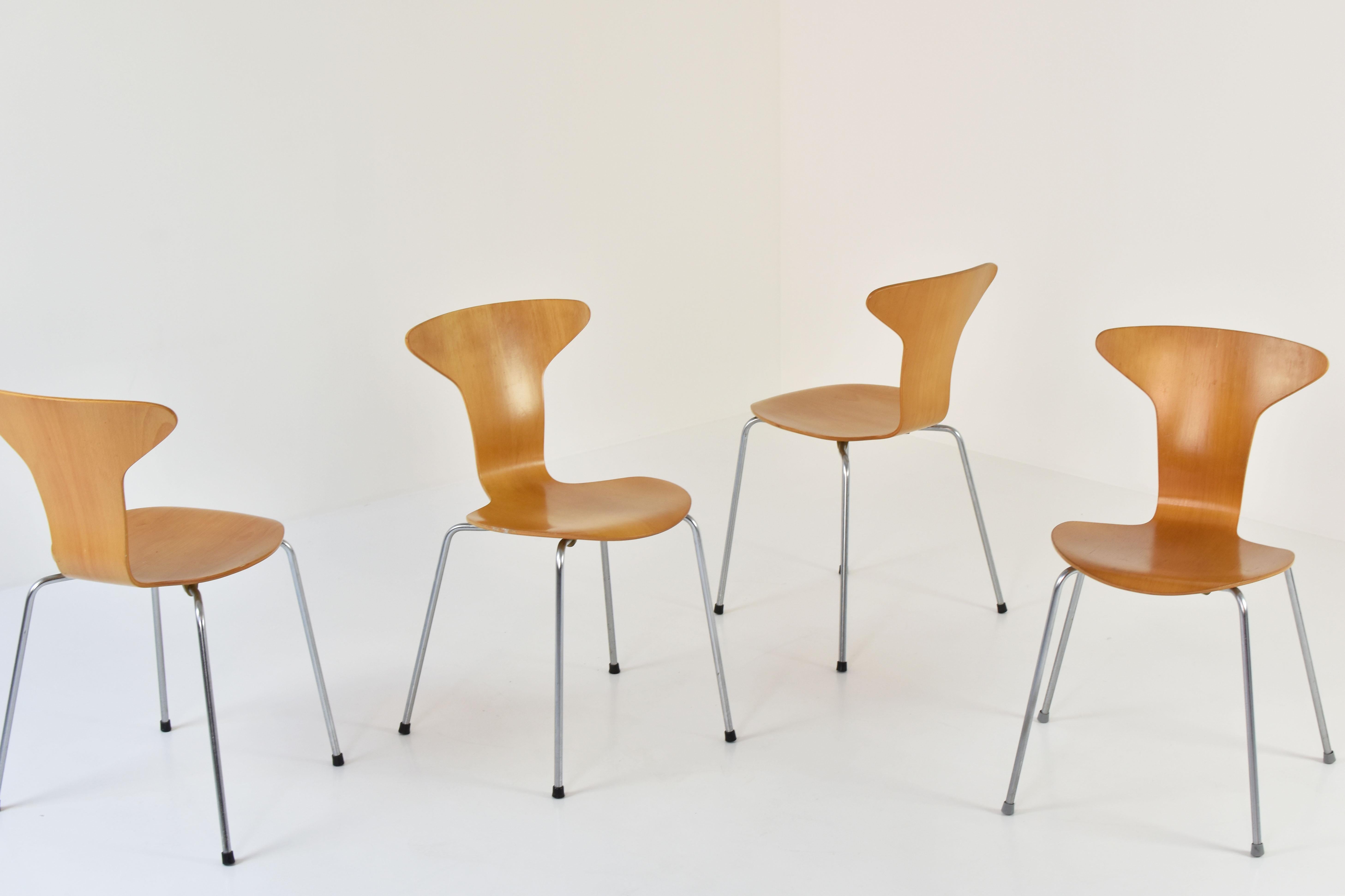 Set of 4 ‘Mosquito’ dining chairs by Arne Jacobsen for Fritz Hansen, Denmark, 1950s. These chairs features a metal base and beech seats. All in good presented condition, labeled underneath.