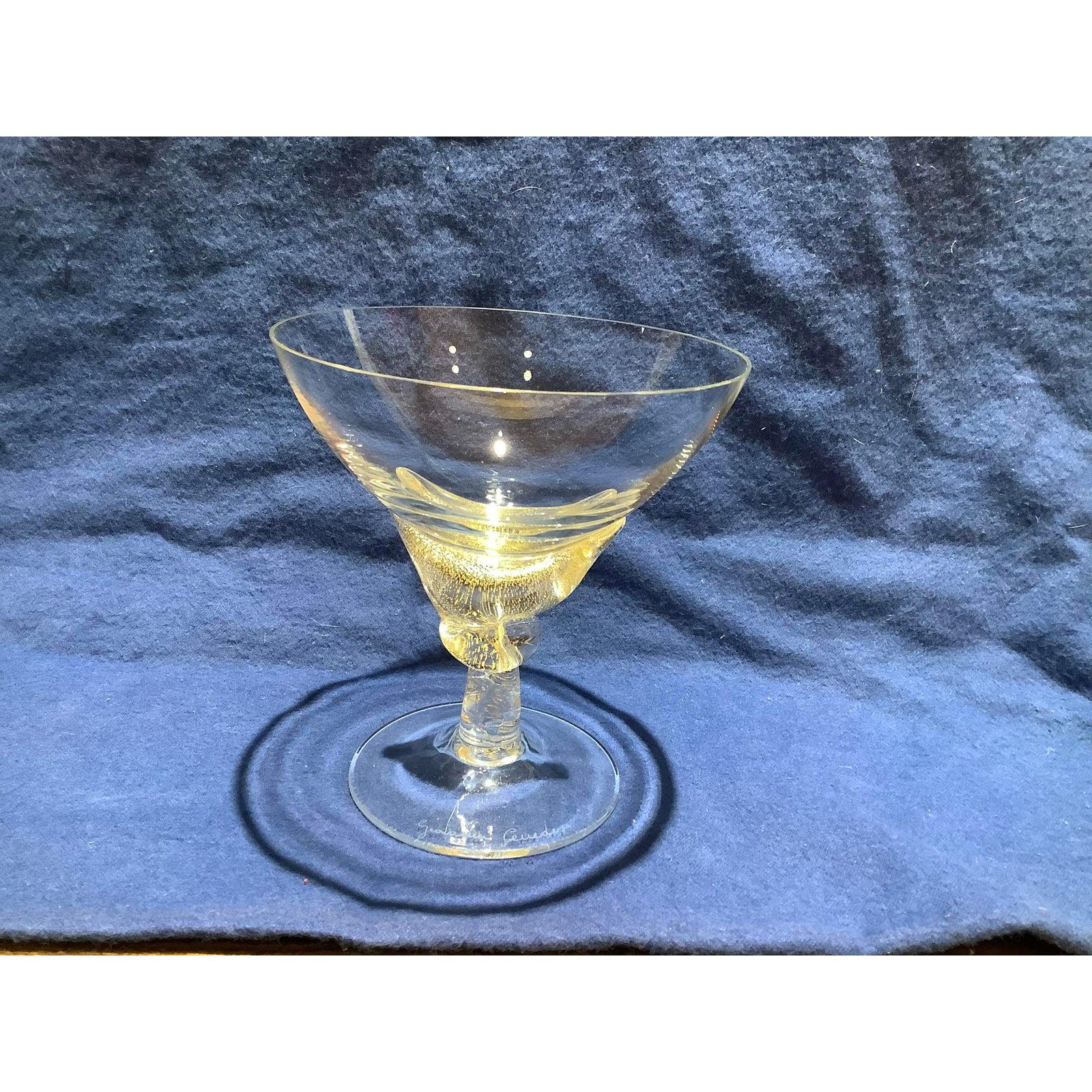 Custom murano glass desert coupes or champagne flutes from the 1970s. These are clear glass with a lot of 24-karat gold flakes. The clear glass is smooth on the outside and rippled on the inside.
Each flute is signed Giovanni