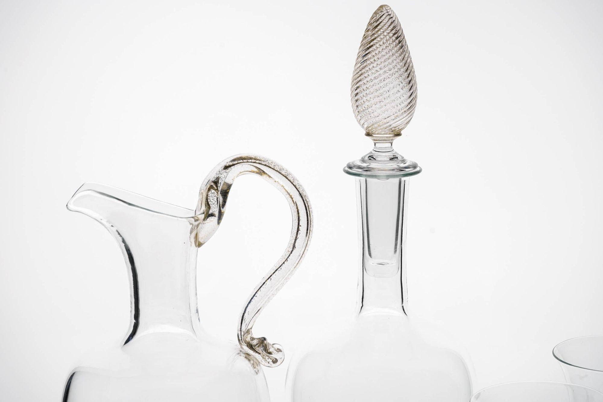 Here an unique and beautiful set made of 4 stemmed glass (two flute and two wine glas) and one bottle with stopper and one pitcher.

They are a showroom sample group. Exquisit manufacturing. The glass are made of a sequence of 7 parts all hand