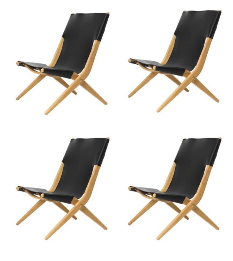 Set of 4 natural oiled oak and black leather saxe chairs by Lassen
Dimensions: W 60 x D 67 x H 84 cm 
Materials: leather, oak.

Mogens Lassen was perceived as ‘the naughty boy in class’, but he aimed for perfection in each design project. His