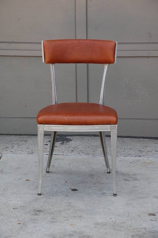 Set of 4 neoclassical aluminum and brown leather dining chairs. Very sturdy and comfortable.