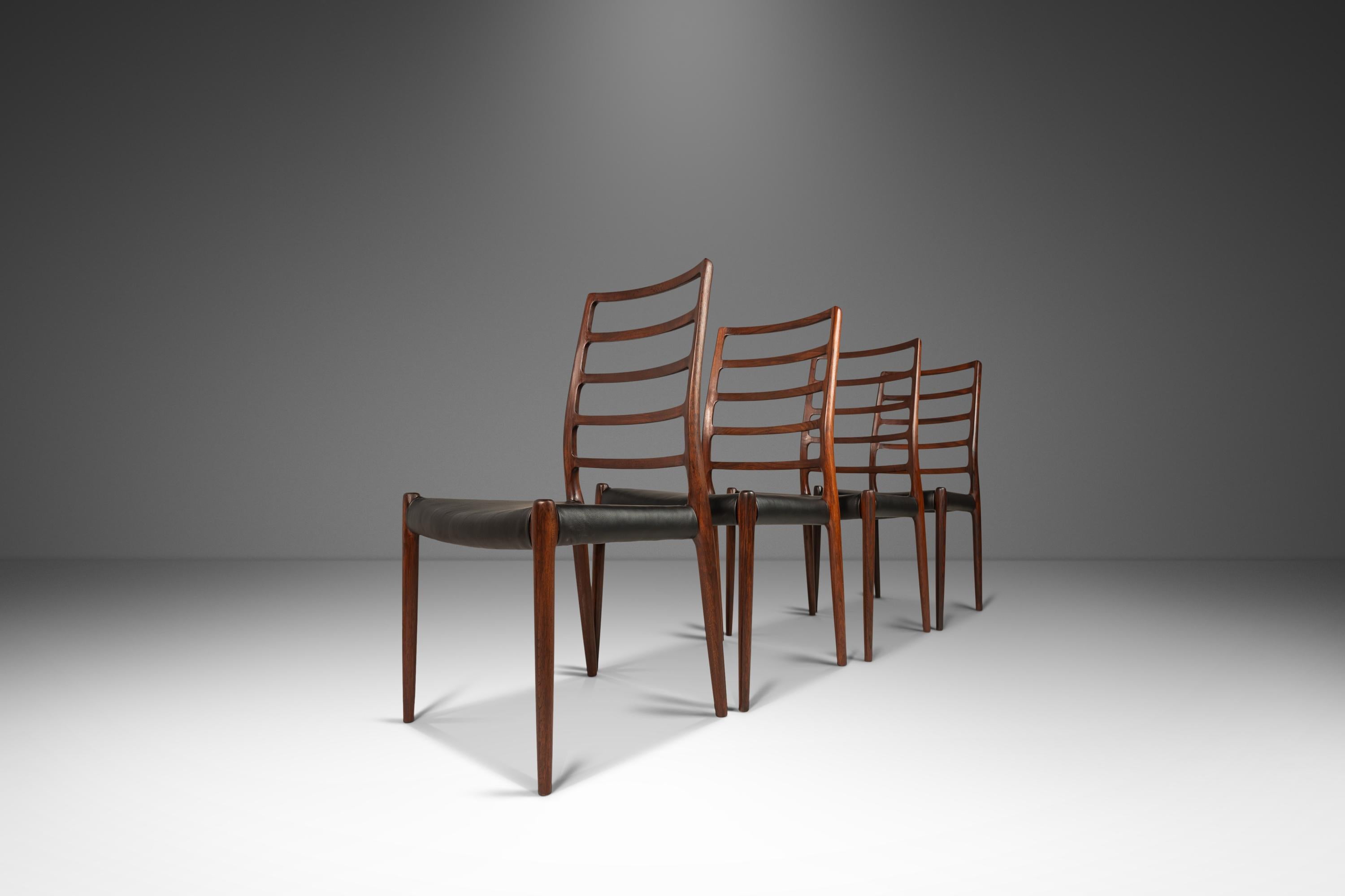 Designed by Niels Otto Møller for JL Møller Møbelfabrik in 1954, the model #82 chair is perhaps one of the most elegant model of the exalted Møller line of chairs. Constructed of sculped solid rosewood the lines and woodgrains of these side chairs