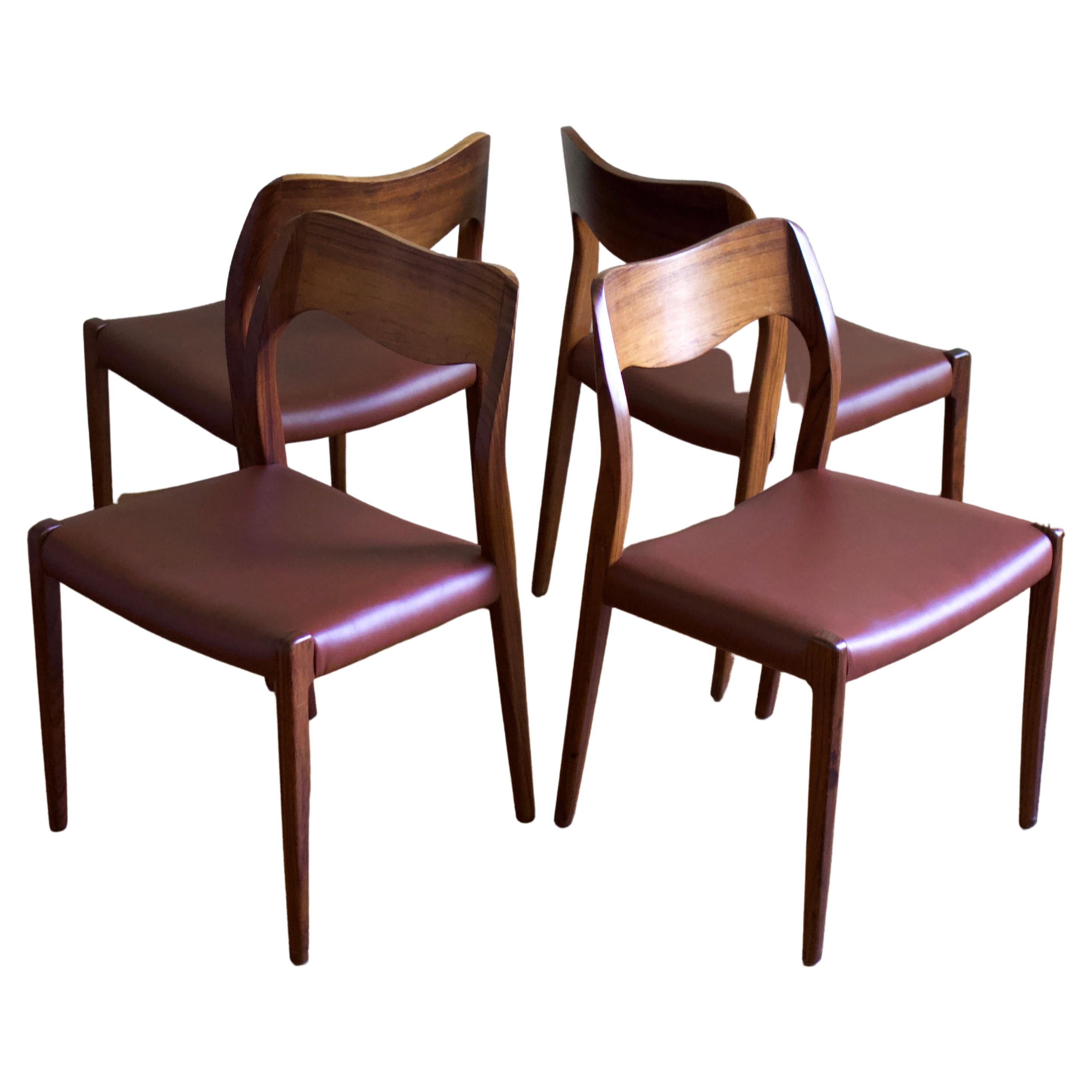 A fantastic set of 4 Møller Model 71 chairs. Sculptural hardwood teak frame and warm cognac leather. Made in Denmark and designed in 1951 by famed 20th century Danish designer Niels Otto Møller. Perfect for any setting requiring sculptural,