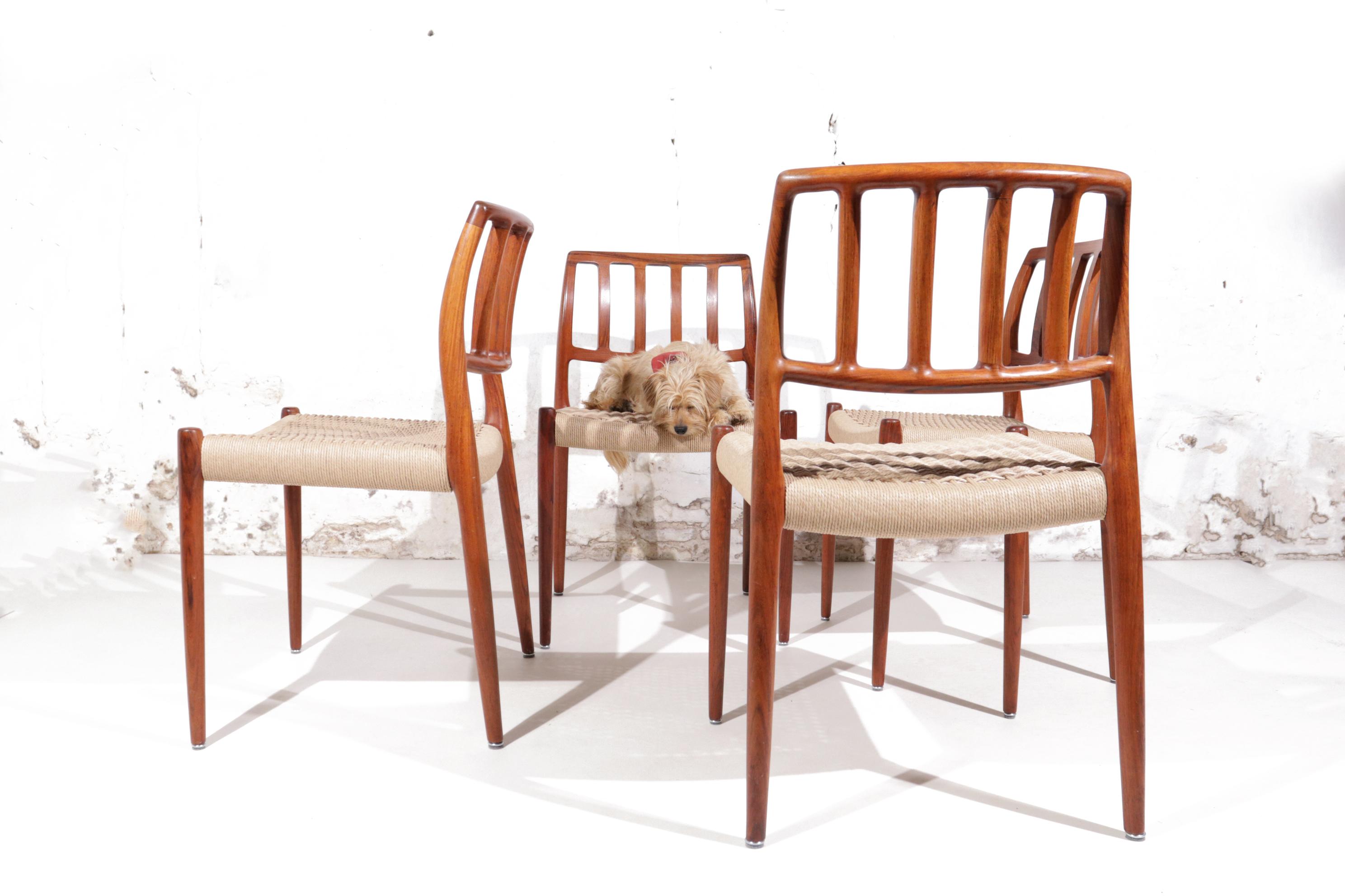 Elegant dining room chairs designed by Niels Otto Moller for J.L. Moller Mobelfabrik in Denmark.
The frame is made of the most beautiful and rare wood type; Rosewood and they are in a very good condition, the paper cord has been completely