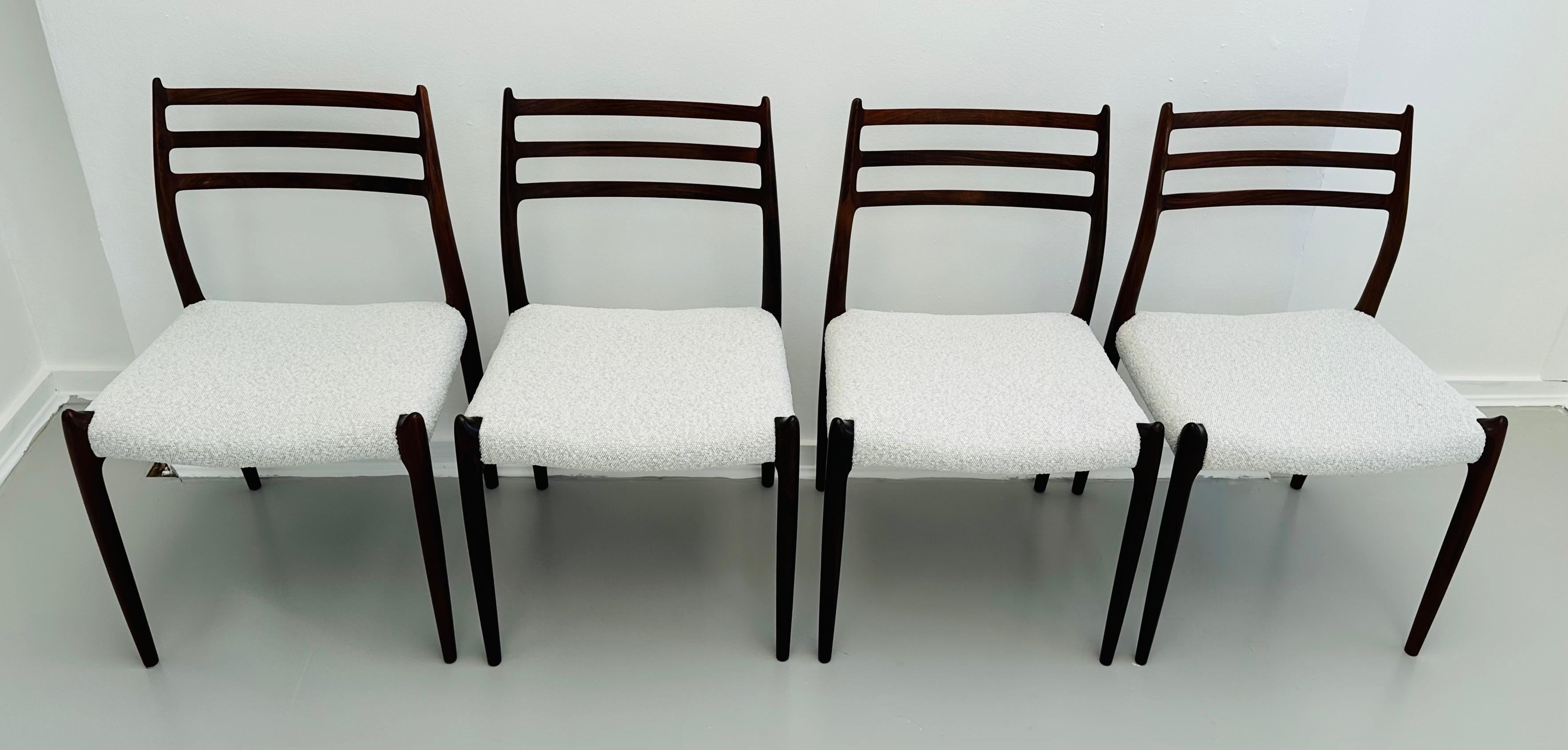 Set of 4 1960s Danish solid Rosewood dining chairs designed by Niels Otto Møller.  Manufactured by J. L. Møllers Mobelfabrik, Denmark in 1962.  Model 78.  The dining chairs have been completely refinished with marshmallow coloured hardwearing boucle