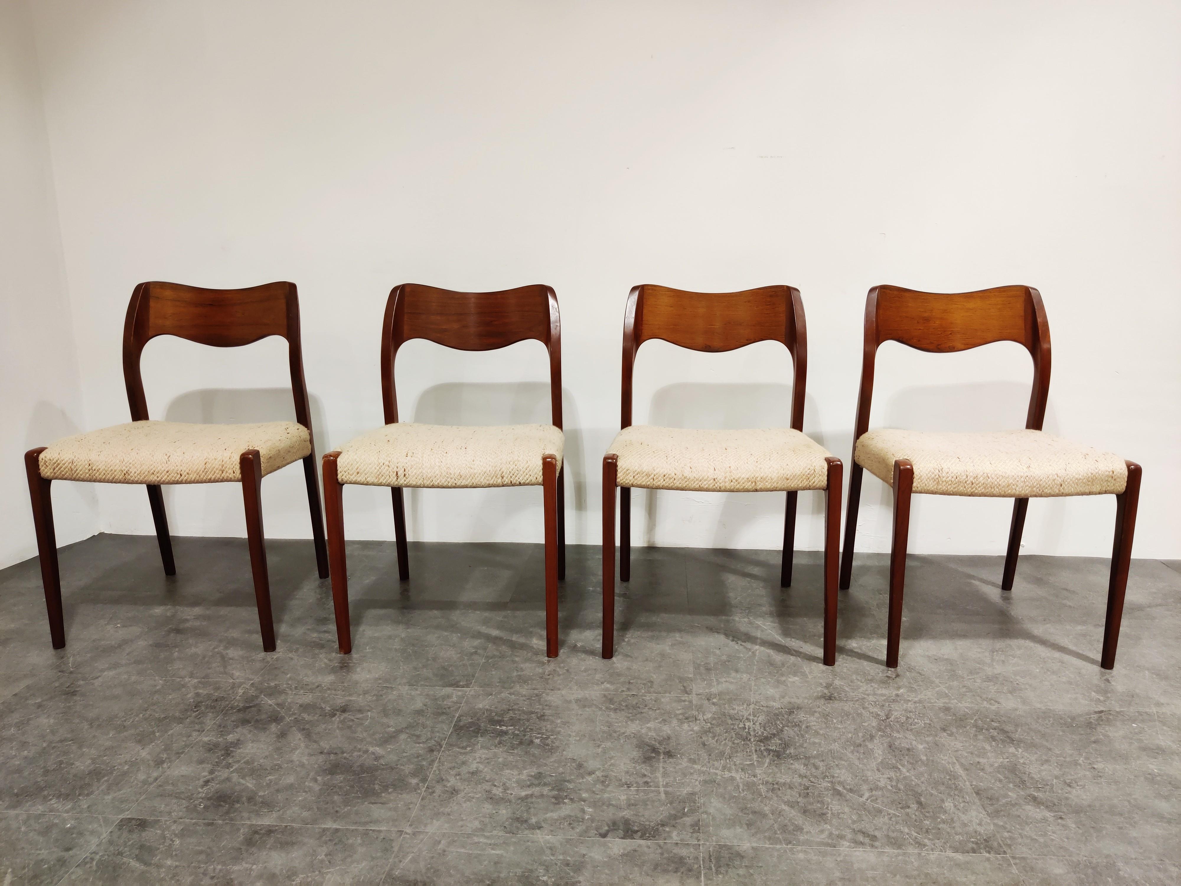 Elegantly shaped set of 4 dining chairs designed by Niels Otto Møller for JL. Mollers.

Beautiful organic shaped teak wood with original beige fabric upholstery.

Good original condition with minor wear, no rips or heavy staining on the
