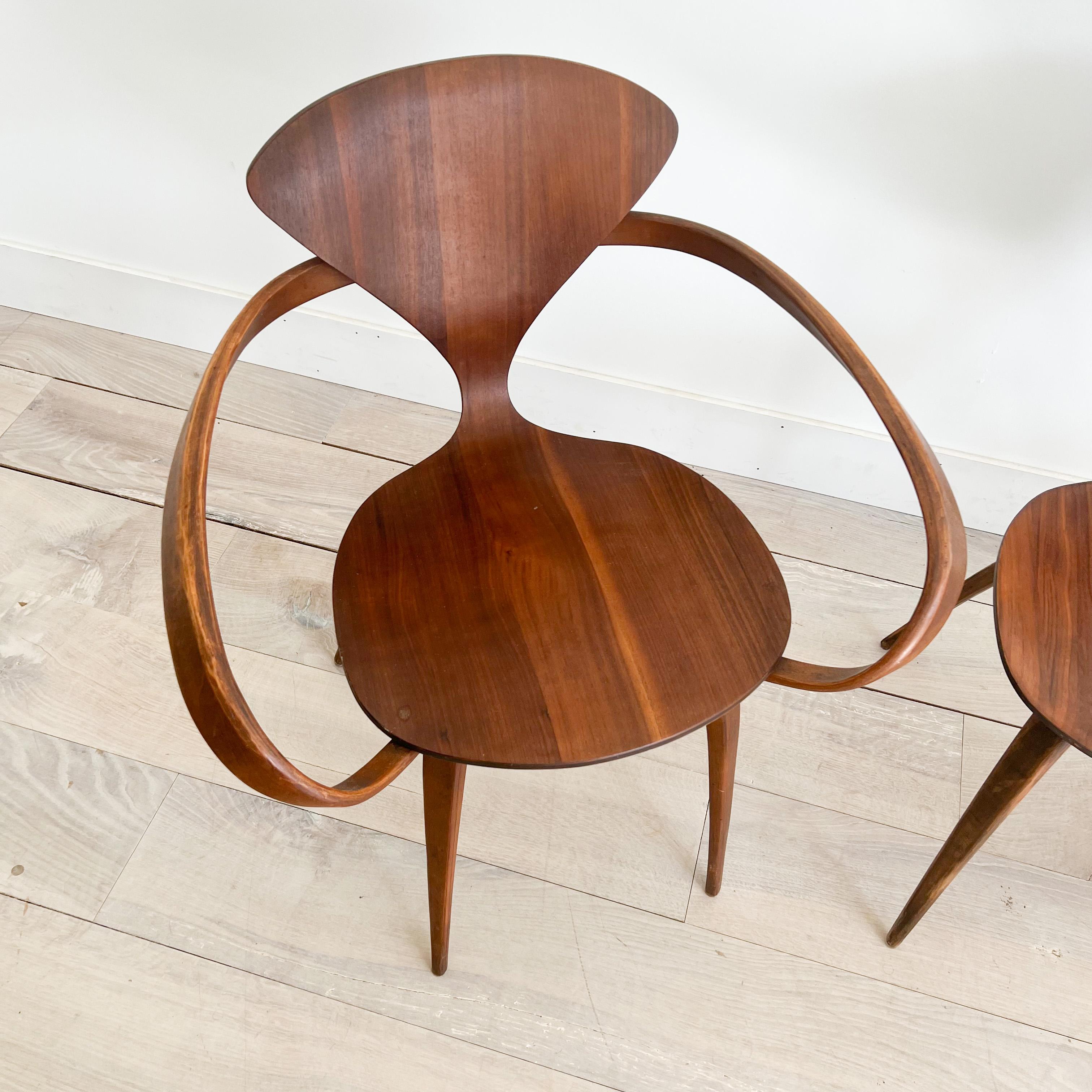 Set of 4 hard to find Mid-Century Modern sculpted “Pretzel” chairs by Norman Cherner for Plycraft. Some scuffing/scratching/small areas of veneer repair from age appropriate wear (see photos for examples). One chair has the Plycraft tag under the