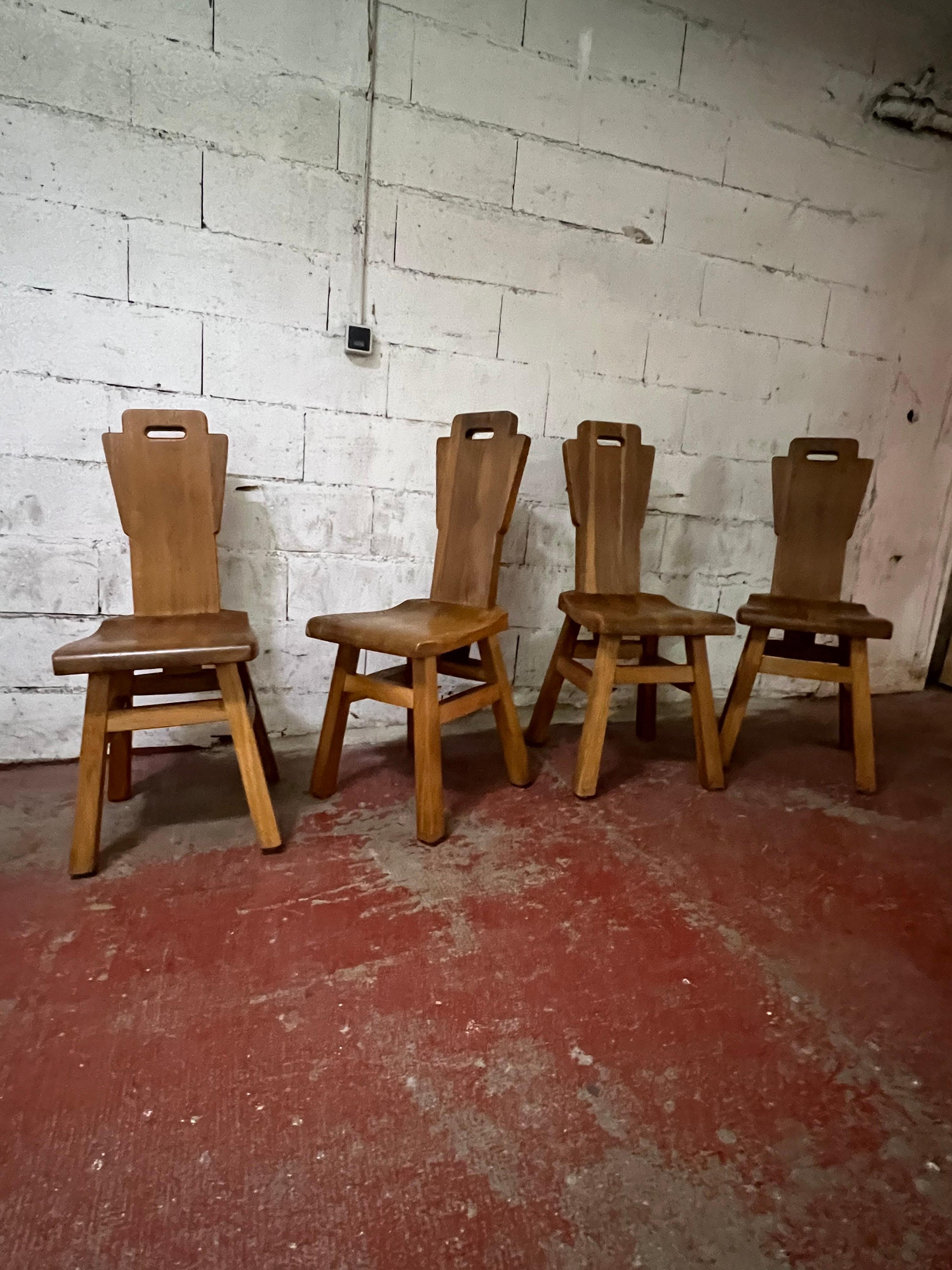 A set of 4 brutalist oak chairs attributed to the Belgium designer de Puydt.