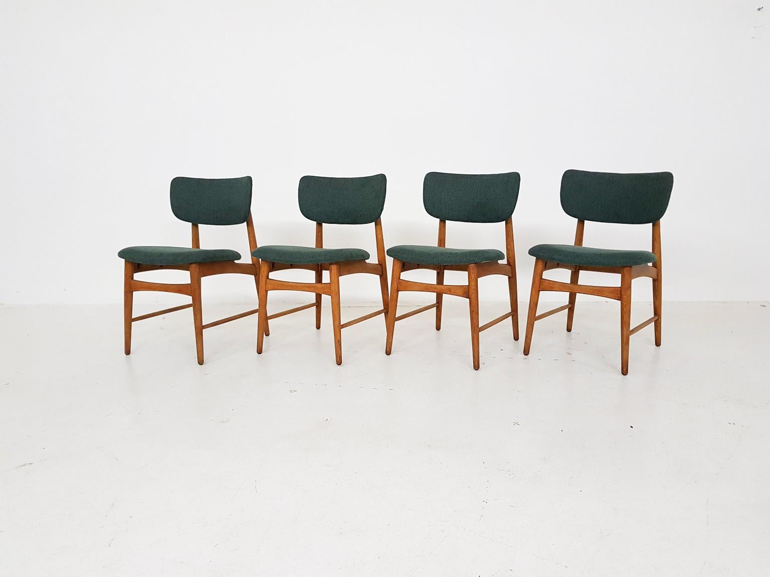 A nice set of oak dining chairs with new green upholstery. 

We think it is a design by the Dutch midcentury furniture manufacturer Bovenkamp, since the oak frame and the shape of the seating and back remind us of other designs. Besides those