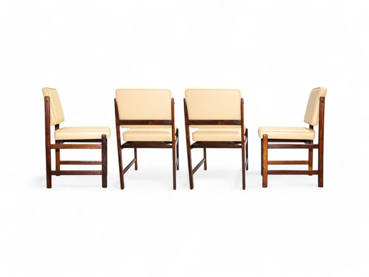 These four chairs boast a simple and minimalist design, featuring frames crafted from beautiful Jacaranda hardwood. The cushions have been upholstered in beige leather, enhancing the clean and understated aesthetic of the chairs. This combination of