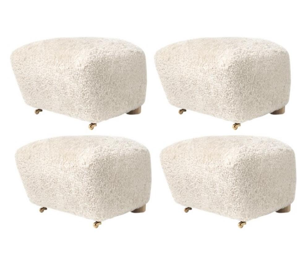 Set of 4 off white natural oak sheepskin the tired man footstools by Lassen.
Dimensions: W 55 x D 53 x H 36 cm 
Materials: Sheepskin

Flemming Lassen designed the overstuffed easy chair, The Tired Man, for The Copenhagen Cabinetmakers’ Guild