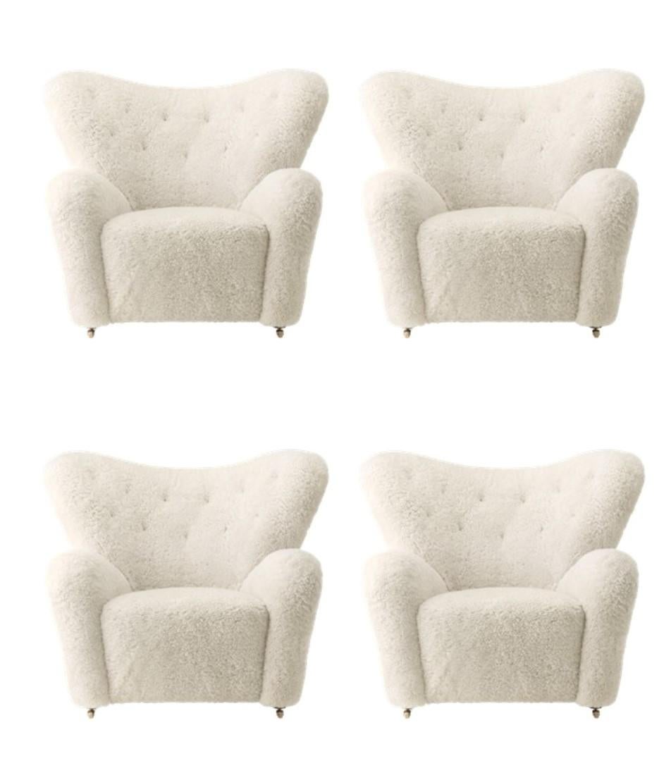 Set of 4 off white sheepskin the tired man lounge chair by Lassen
Dimensions: W 102 x D 87 x H 88 cm 
Materials: Sheepskin

Flemming Lassen designed the overstuffed easy chair, The Tired Man, for The Copenhagen Cabinetmakers’ Guild Competition