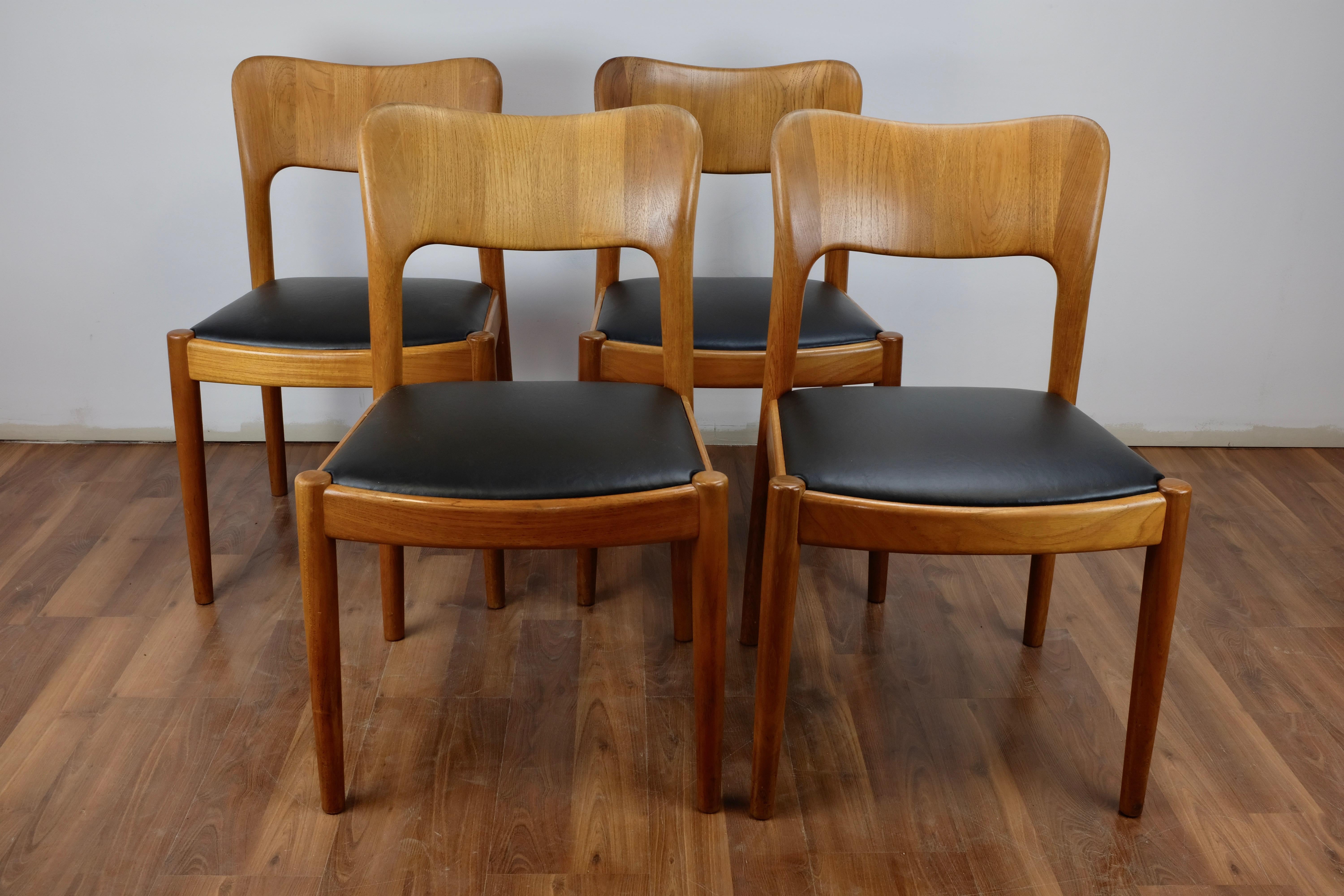 Set of 4 teak Ole dining chairs designed by John Mortensen and made in Denmark by Koefoed-Hornslet. 

Constructed of solid teak and in excellent condition with new black leatherette upholstery.