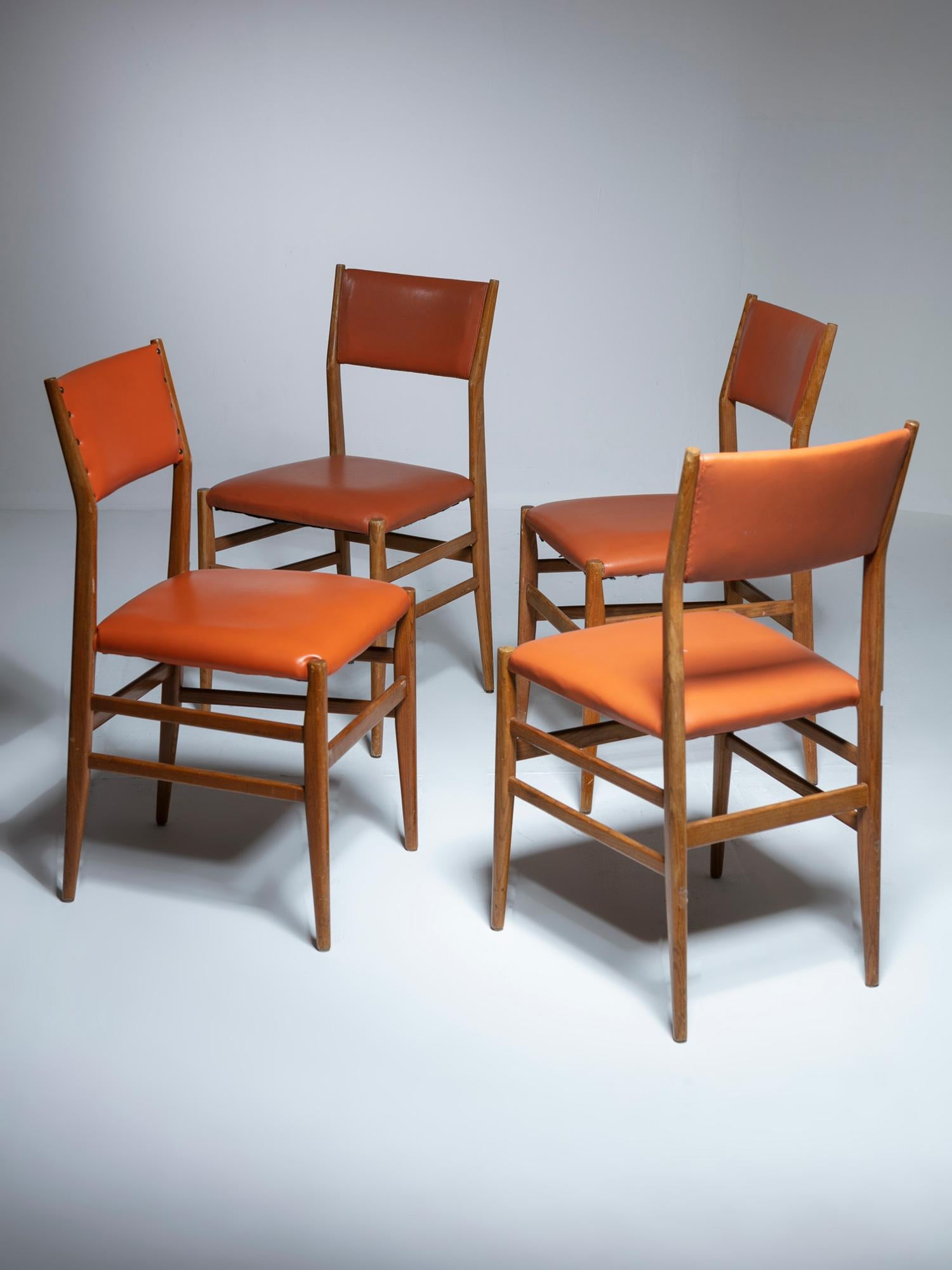 Four chairs model 646 by Gio Ponti for Cassina.
Rare version with upholstered backrest.
Set features three chairs come with same color and the fourth one in a different color.