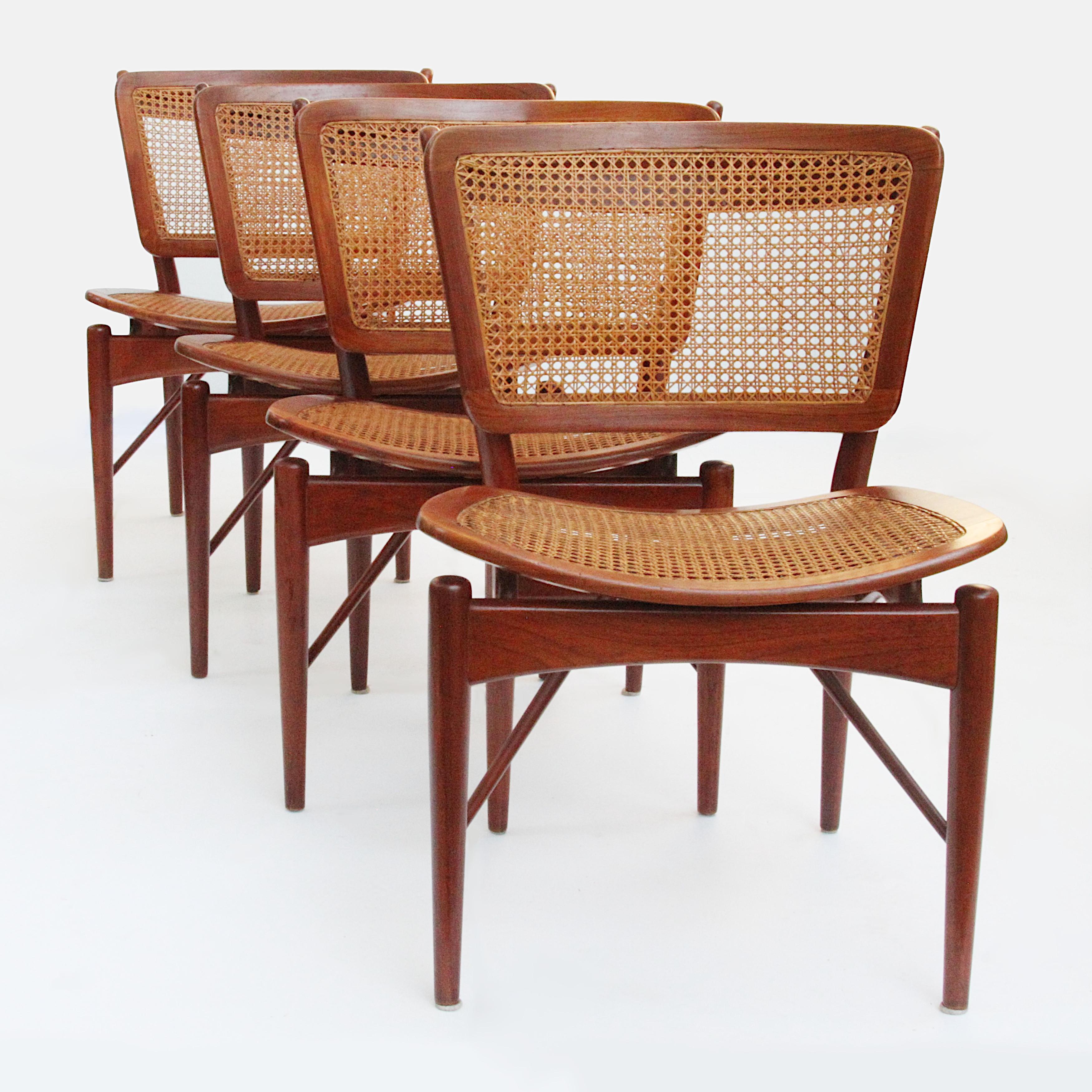 Magnificent set of Model 51/403 chairs designed by Finn Juhl for Baker's Modern line. Chairs feature beautifully sculpted, solid teak frames and woven cane inserts. These chairs are in remarkable original condition with a wonderful patina to the