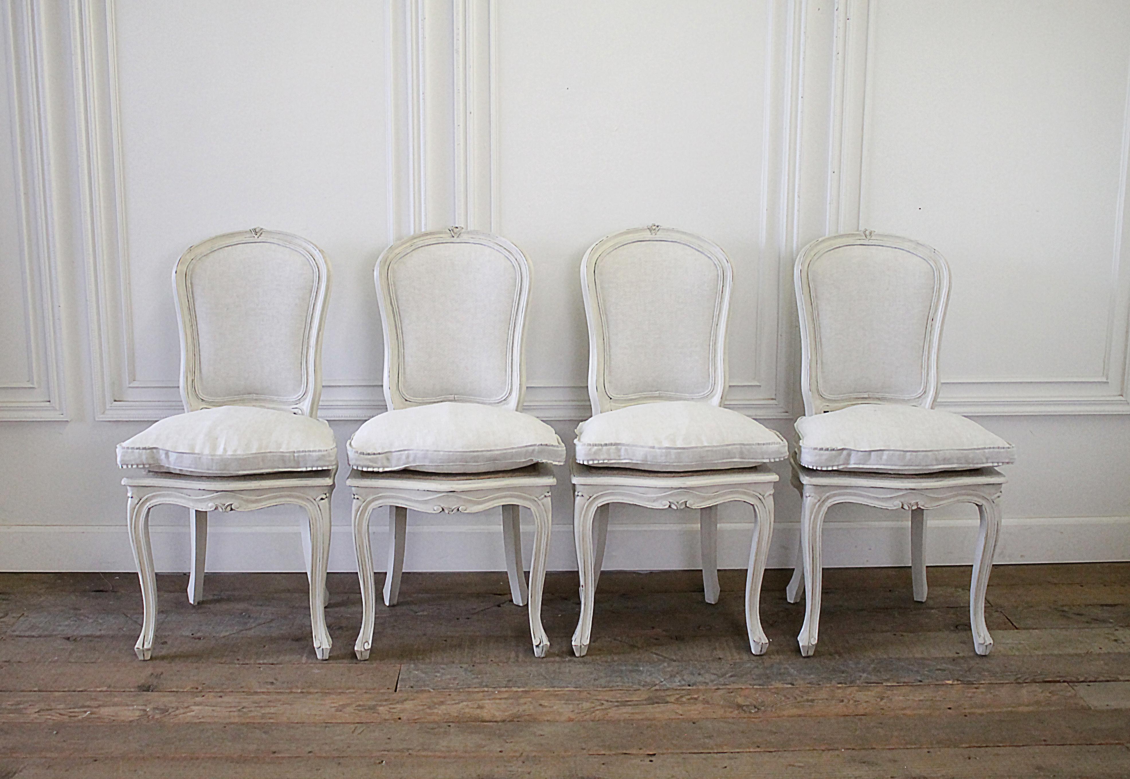 Set of 4 painted and upholstered linen Louis XV style dining chairs
Painted in our signature soft white, with subtle distressed edges, and finished with an antique glazed patina. We reupholstered the backs in our natural Belgian linen and added a