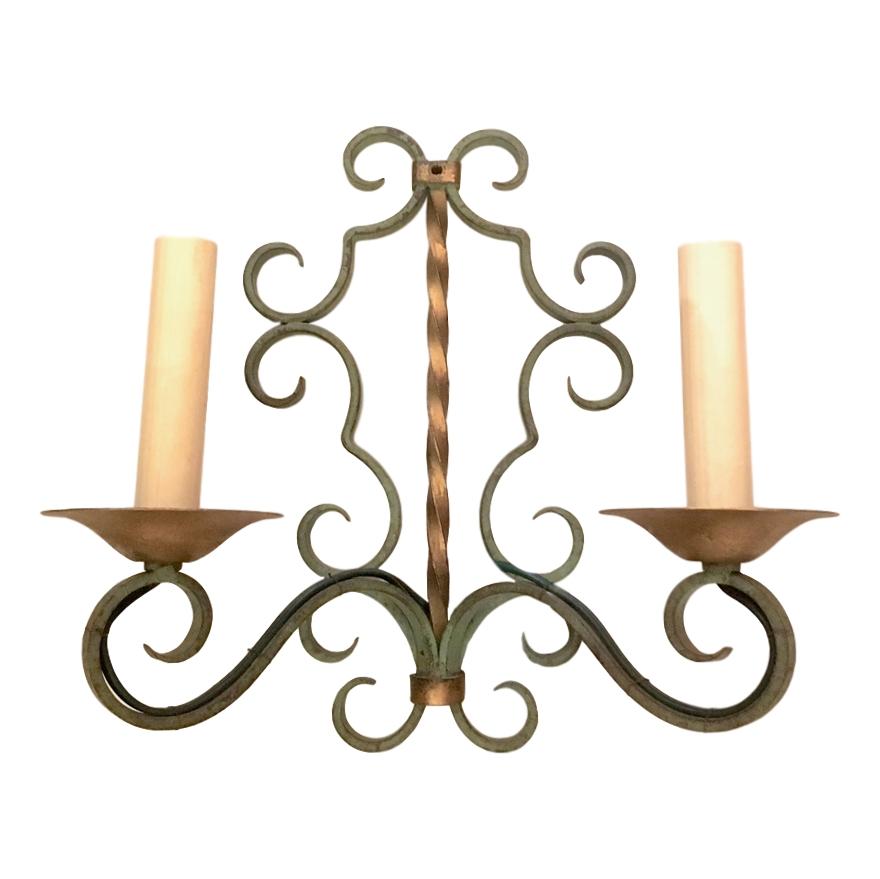 Set of four circa 1940's French wrought iron sconces with 2 lights each. Sold per pair.

Measurements:
Height: 11