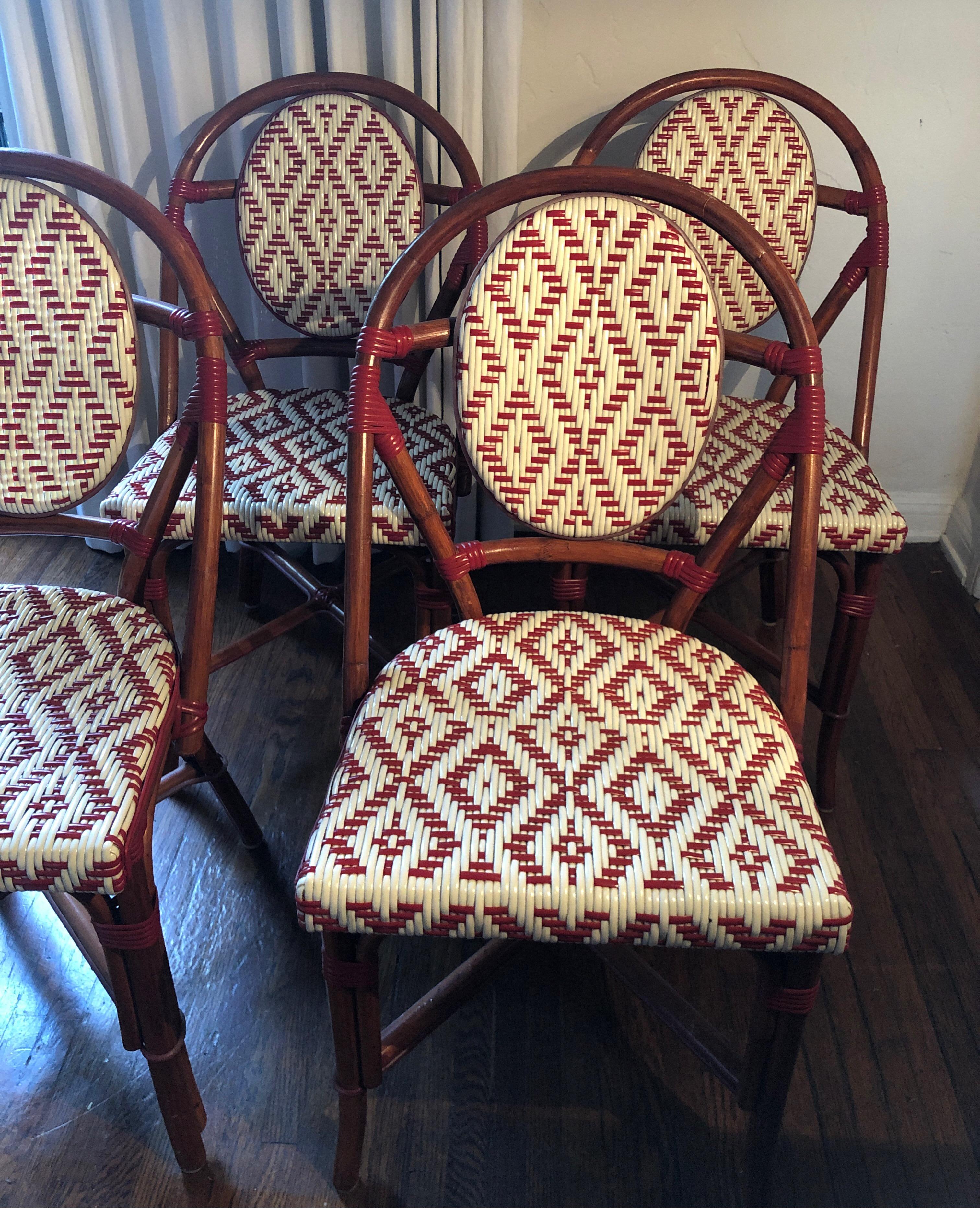French bistro chairs by Palecek.
Red and white basket weave with bamboo frames.

Overall good used condition. See pics 
Some loss on the legs and loose pieces of resin around legs.