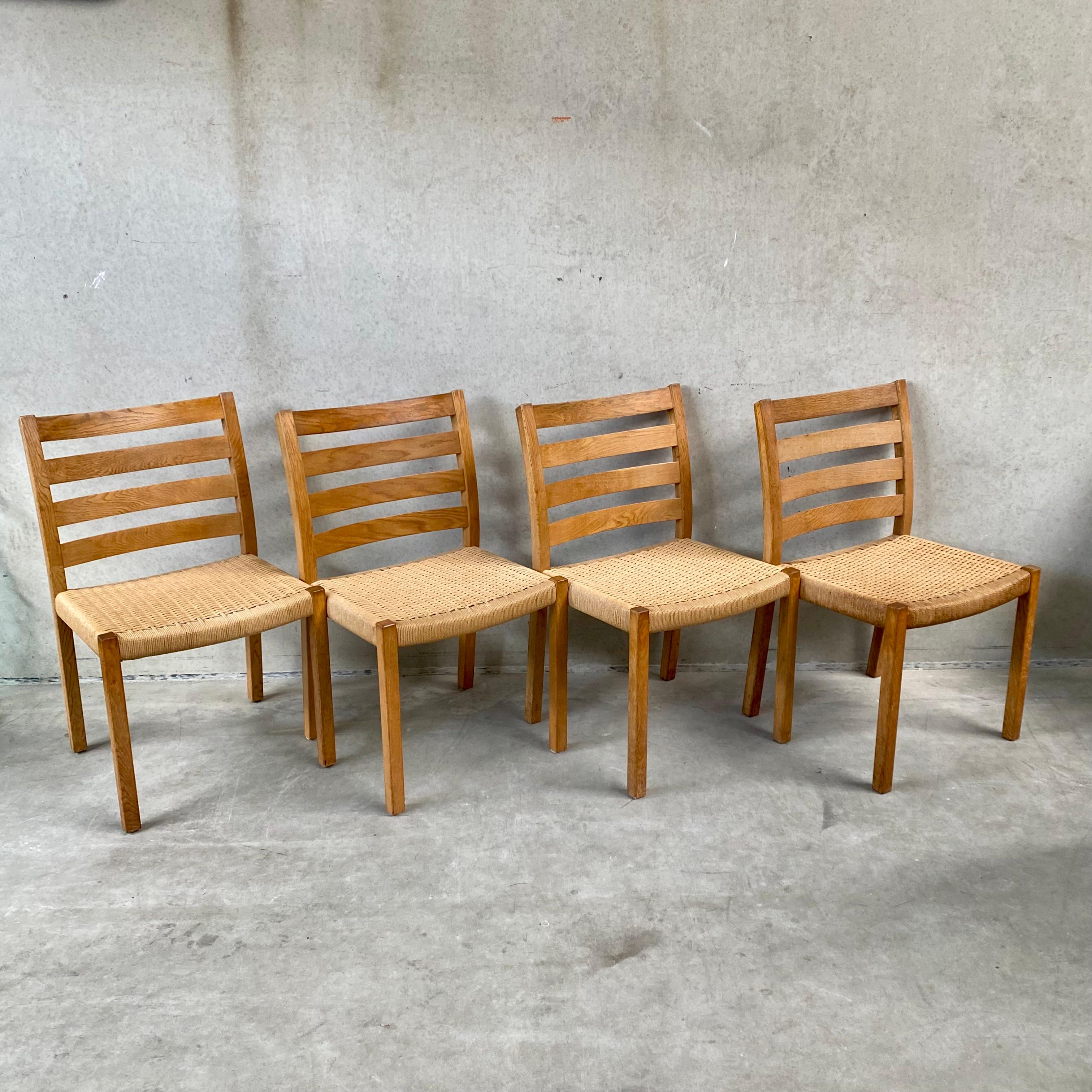 Introducing the exquisite set of 4 dining chairs by J.L. Møllers Møbelfabrik - a testament to the timeless elegance of Scandinavian design. The model 408 chairs feature a stunning papercord seat and sturdy birch wood frame, making them both