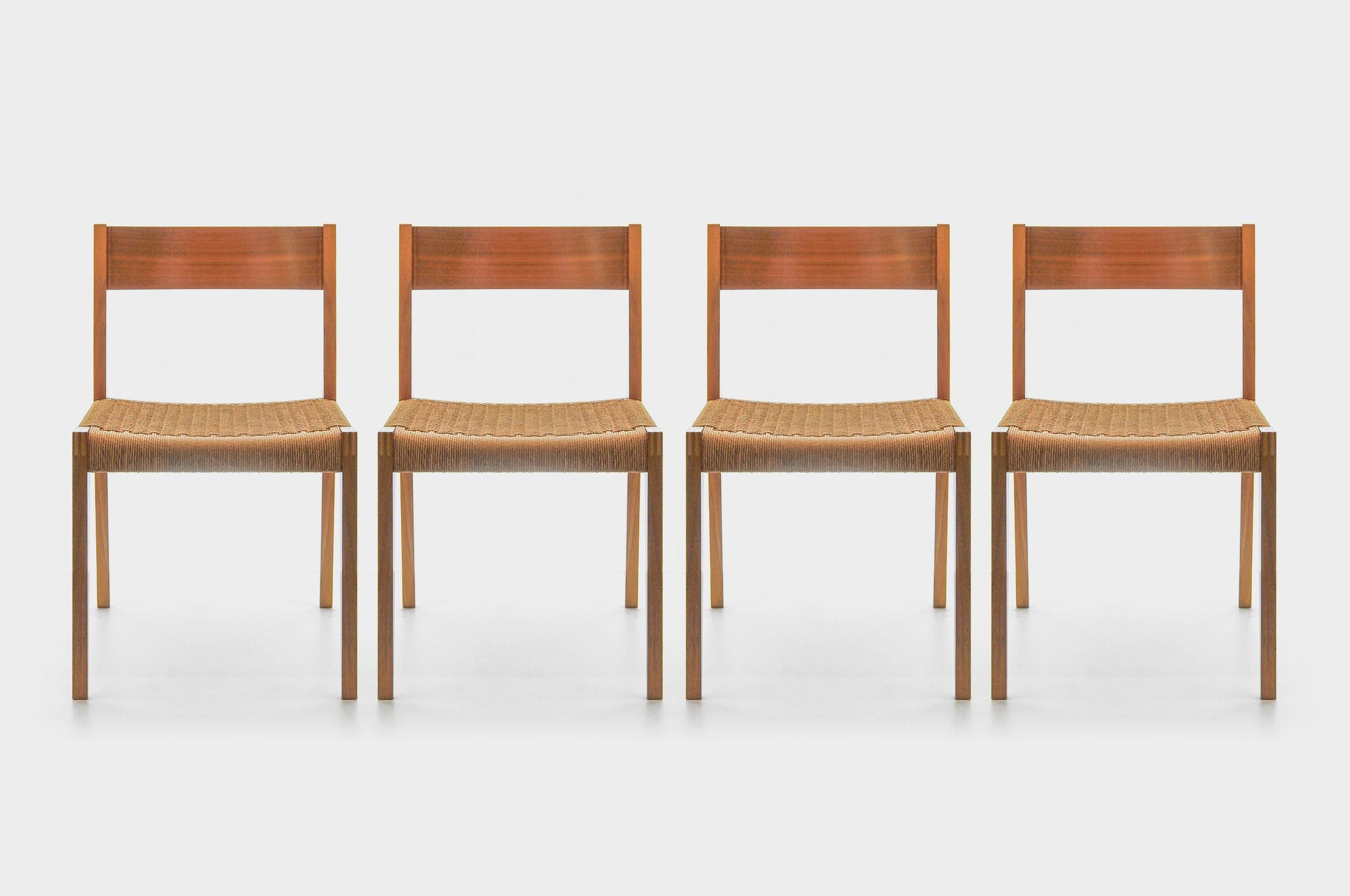 Simple, elegant dining chairs designed by Poul Cadovious. Built by the Swiss manufacturer Girsberger. Very nice workmanship with finger-jointed front legs and filigree curved backrest made of plywood. The hand woven raffia is everywhere intact, firm