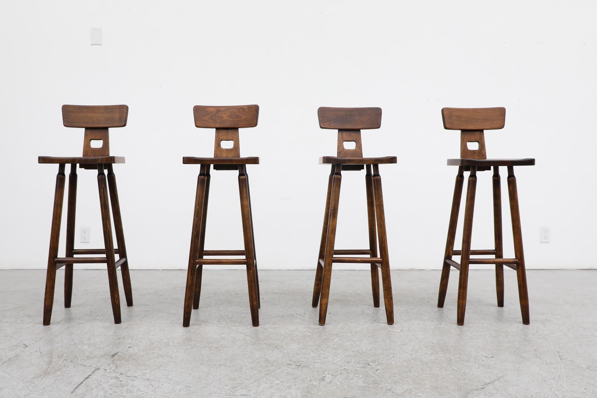 Set of 4 Pierre Chapo inspired, Mid-Century brutalist, T-back bar stools with small handle cut-out and attractively tapered legs. In good original condition with visible wear, including scratching and chipping. Seat width is 13.875
