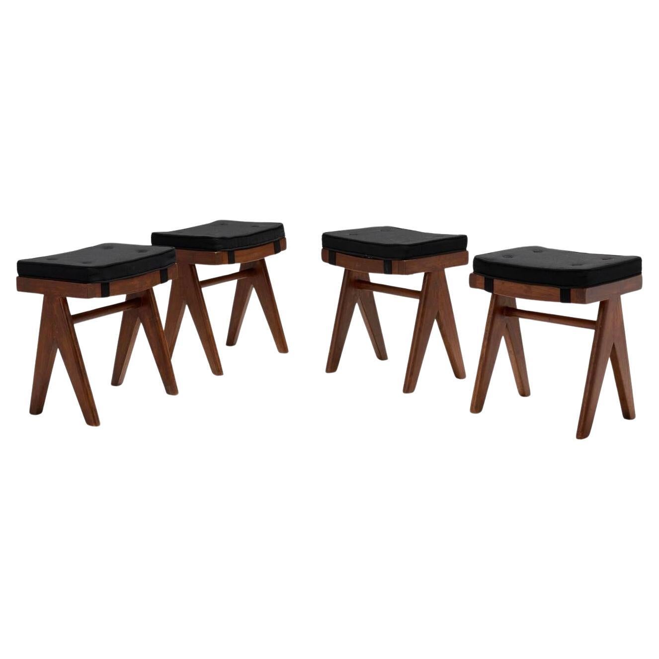 Set of 4 beautiful Pierre Jeanneret stools in the most elegant combination of teak wood with black cushions. The simplicity of the design, yet robust and functional has inspired many versions all over the world, but these original pieces still