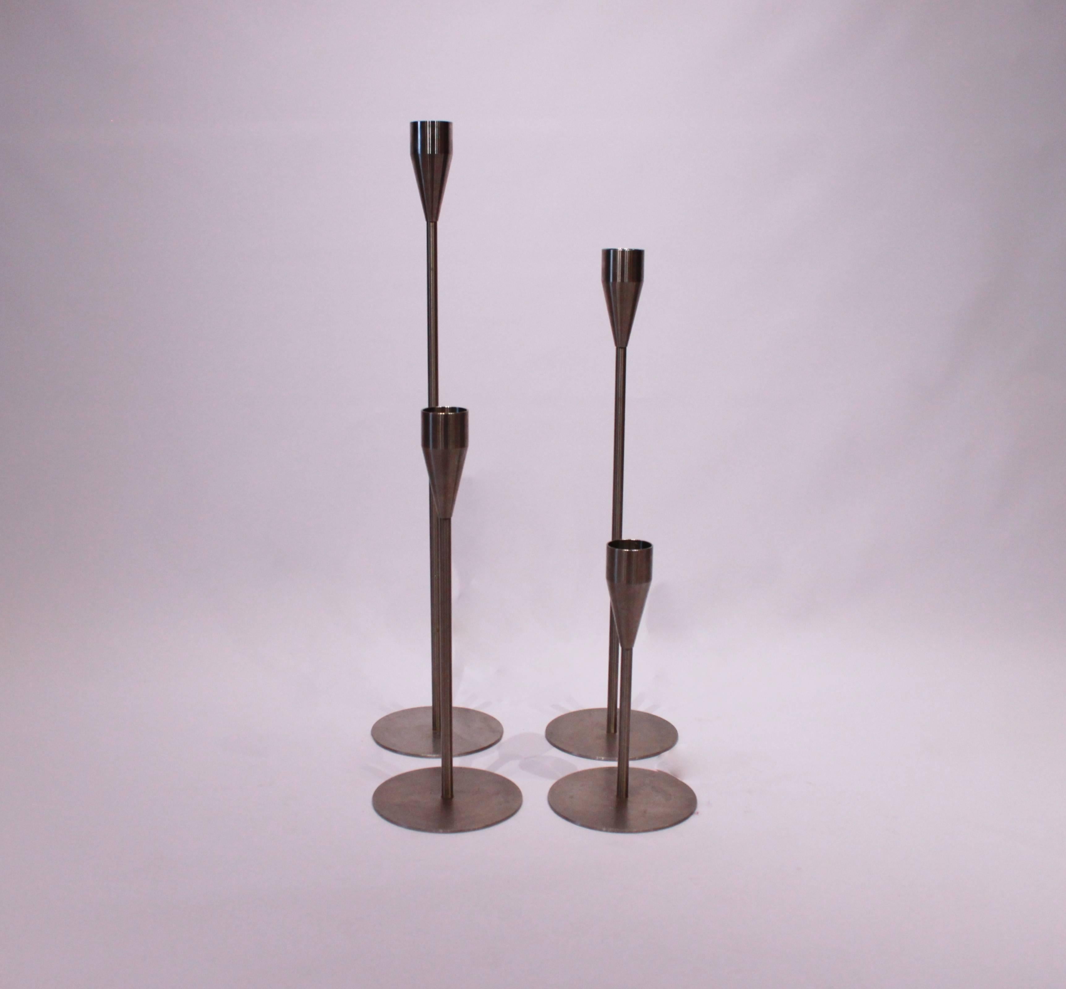 Set of four Piet Hein Maxi candlesticks, Saturn, Jupiter, Venus and Mars, in brushed steel.