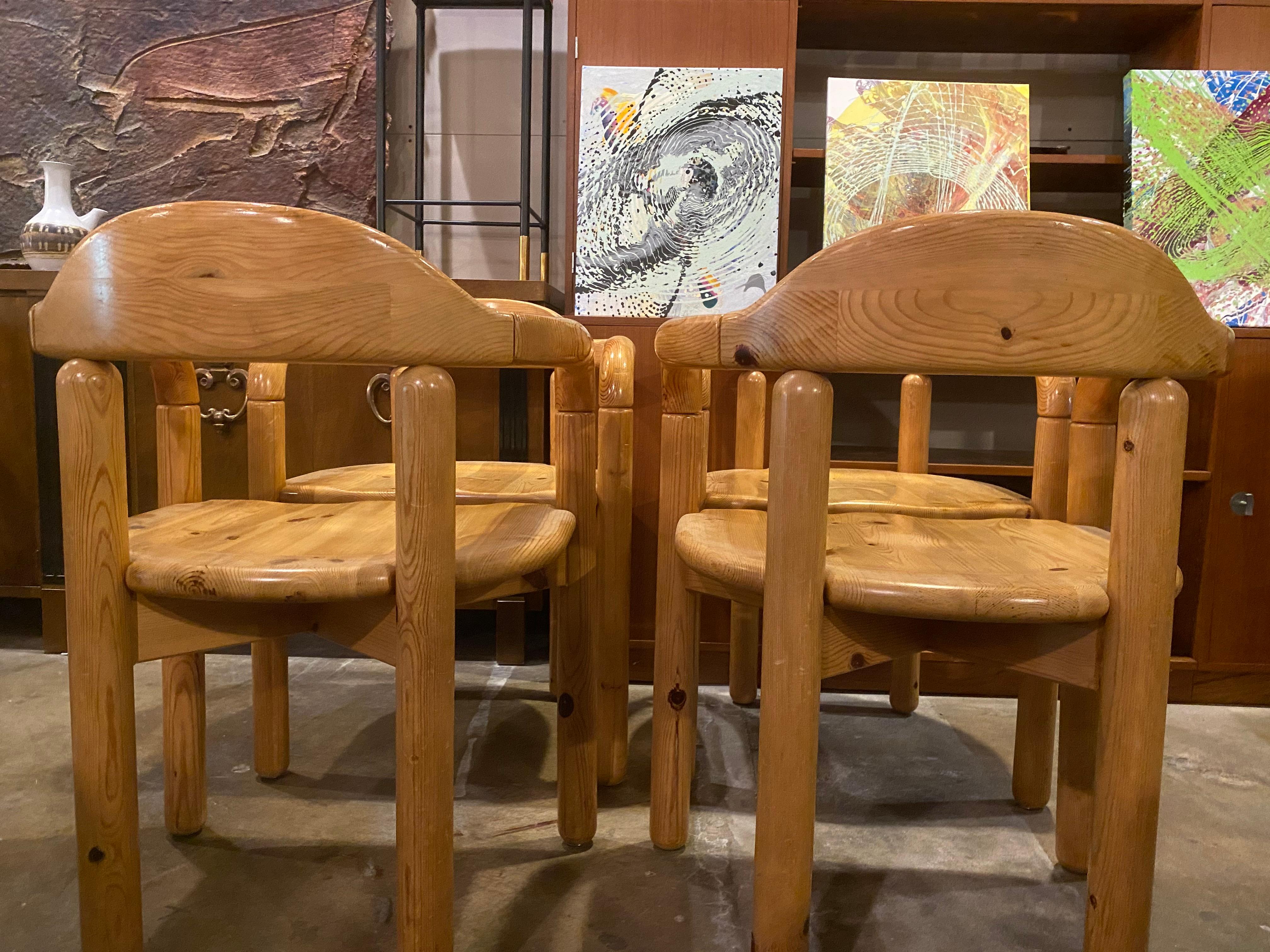 Set of beautiful solid pine Danish chairs by Rainer Daumiller come in a set of 4 feature curved arms and seating and are in good condition. Rainer Daumiller is a Postwar & Contemporary artist.