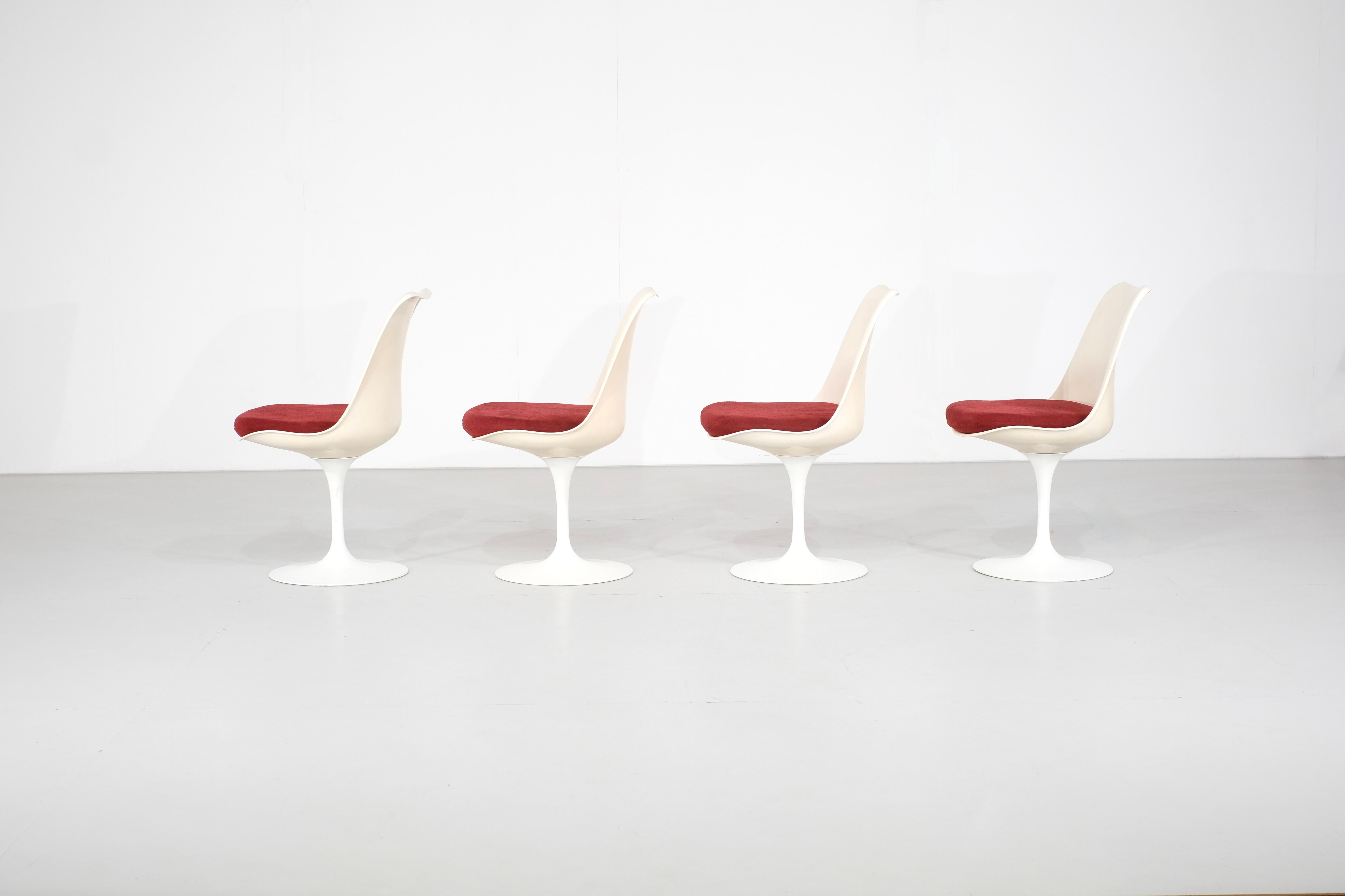 Magnificent set of four swivel tulip chairs designed by Eero Saarinen for Knoll International in the 1960s.

This set of four is in its original condition; nothing has been touched or retouched. The original burgundy-colored cushions are signed