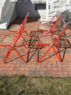 Juego de 4 sillas plegables italianas "Plia "Lucite naranja de Piretti para Castelli