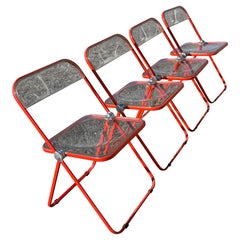 Ensemble de 4 chaises pliantes italiennes "Plia" en lucite orange par Piretti pour Castelli