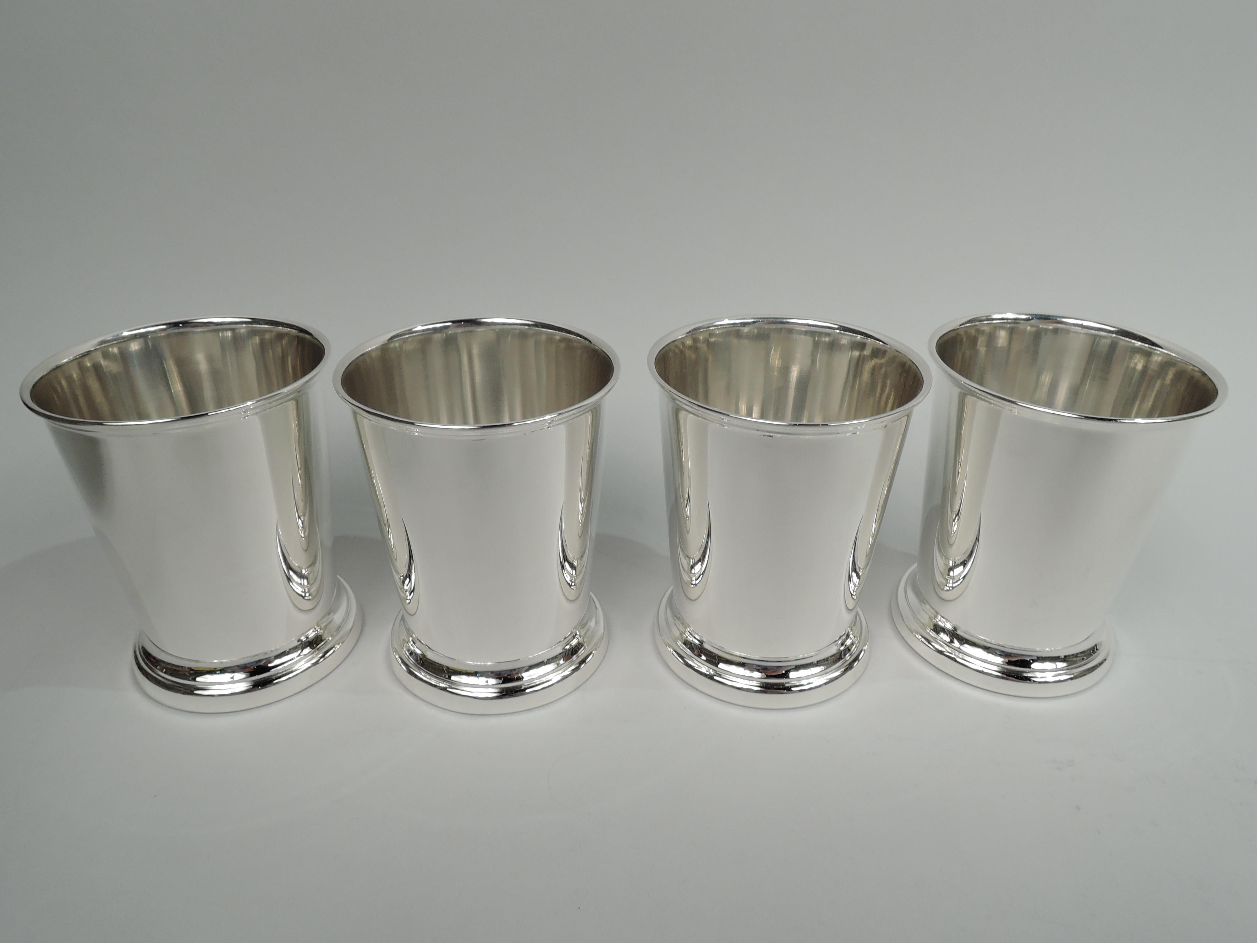 Set of 4 sterling silver mint julep cups. Made by Poole in Wallingford, Connecticut. Each: Straight and tapering sides, molded rim, and skirted foot. Marked “Sterling by Poole” and numbered 58. Total weight: 11 troy ounces.