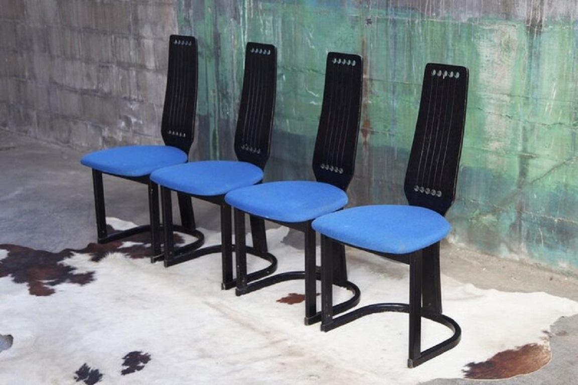 Set of 4 Norwegian Post-Modern sculptural and incredibly unique statement dining chairs.
The seats are upholstered in a blue wool, and can easily be updated by our in house upholsterer upon request.

Additional information:
Materials: