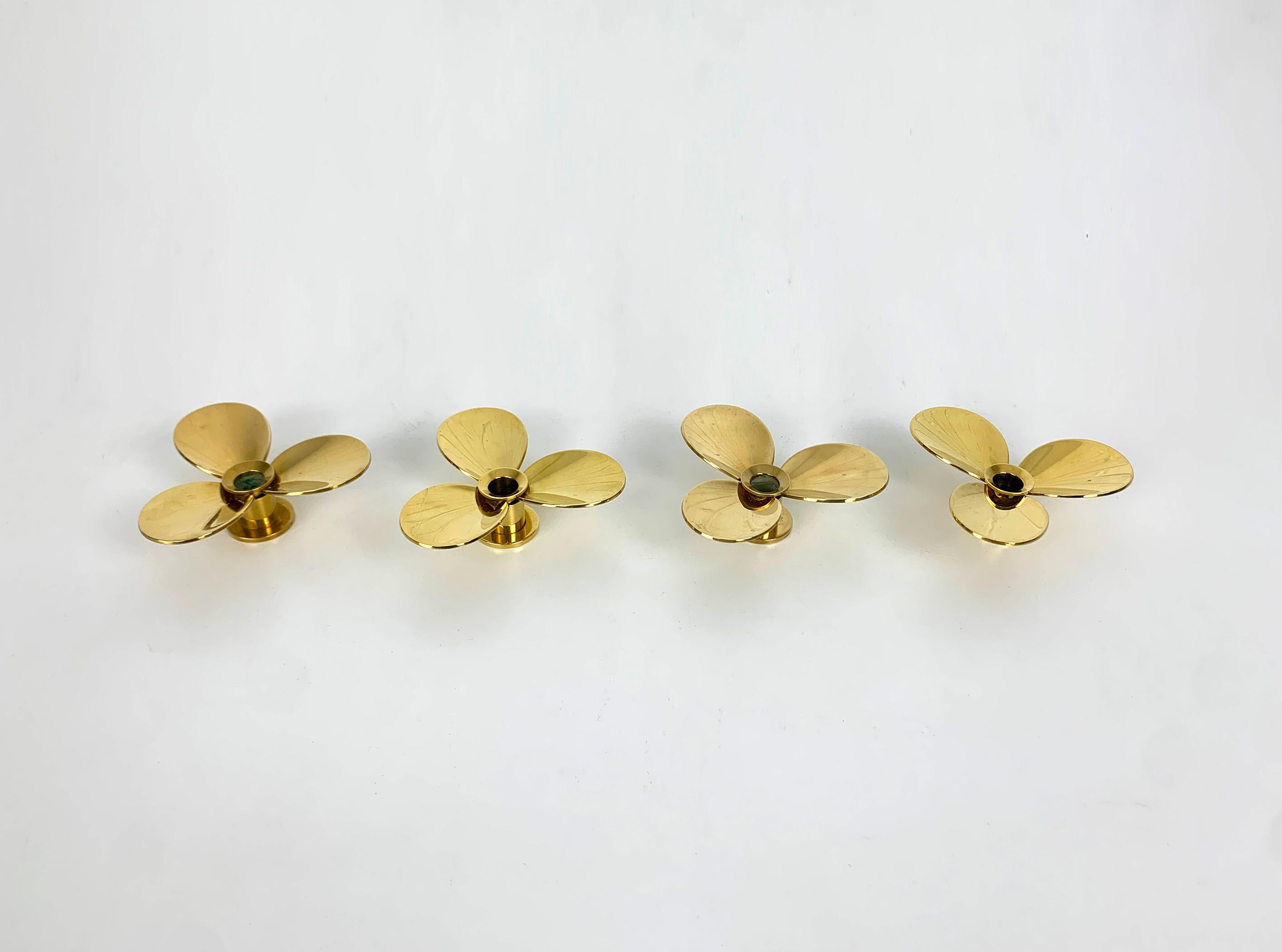A set of 4 candle-sticks made of solid brass, created by Pierre Forssell. Model 