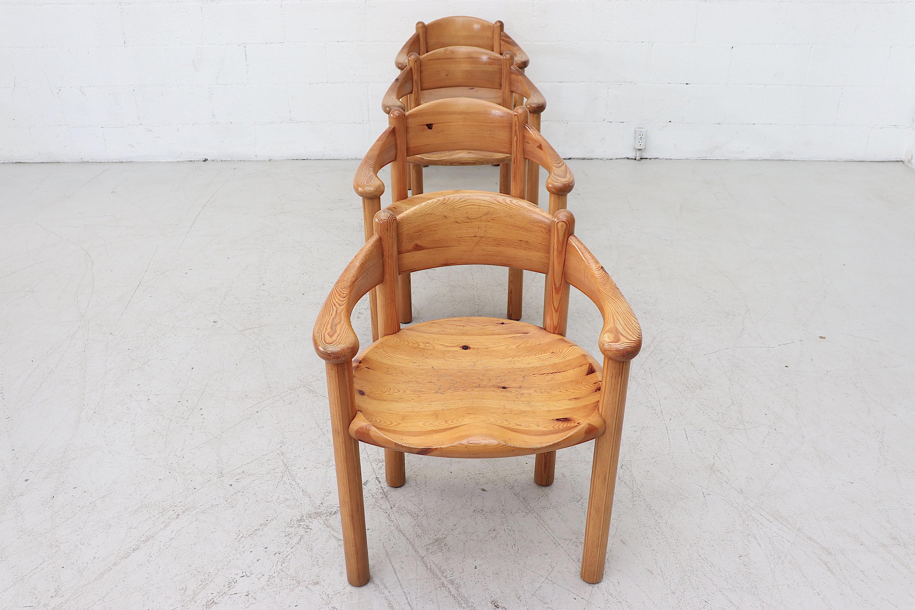 Elegantly carved naturally finished Rainer Daumiller style pine dining chairs. In original condition with wear attributed to age and use. Set price.