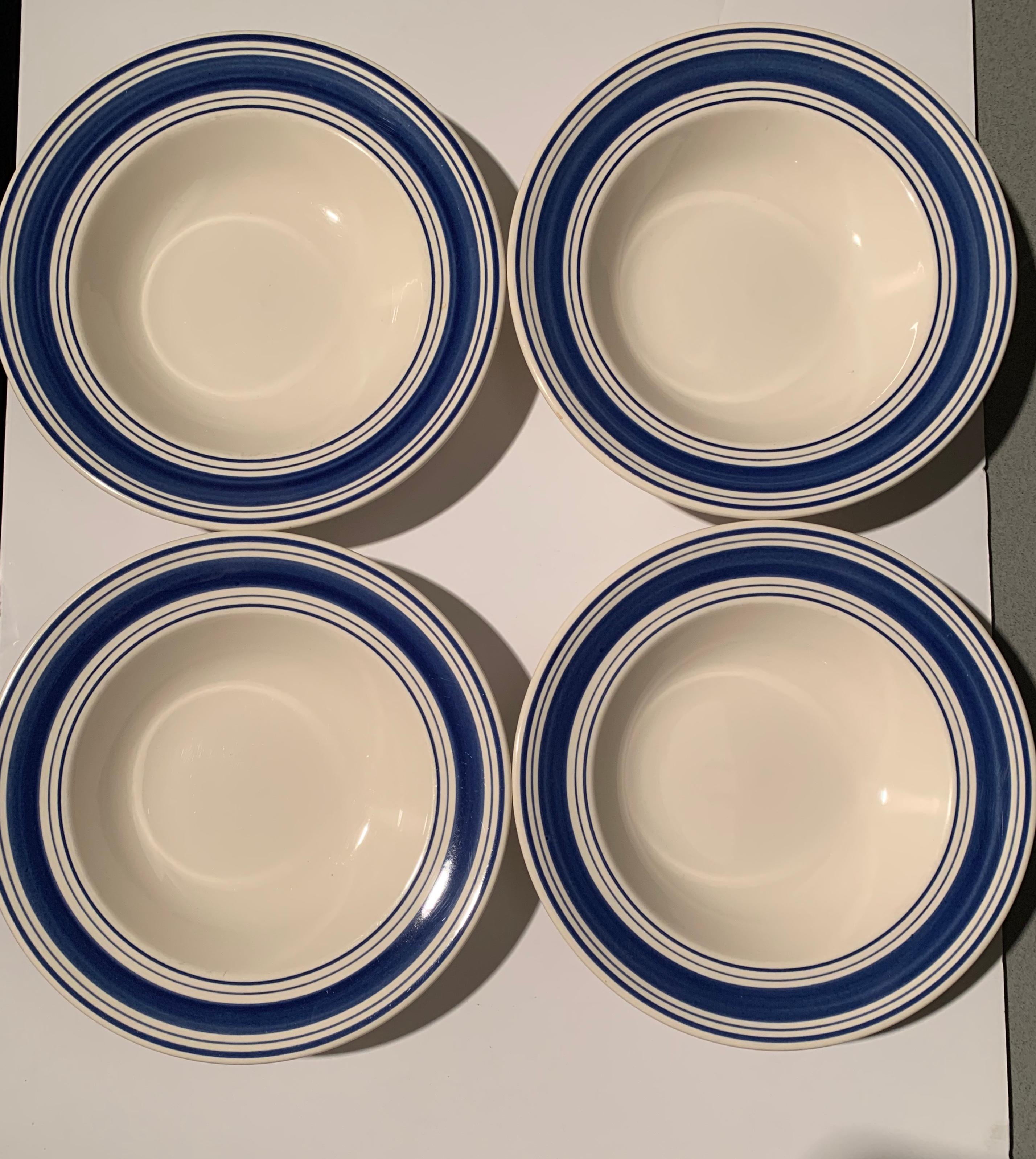 A set of four (4) rimmed soup bowls / pasta bowls in the Farmstead blue and white pattern by Ralph Lauren Home collection. Signed. Ironstone. Made in England; circa 1990.

Features a blue and white ticking-inspired striped border on white.