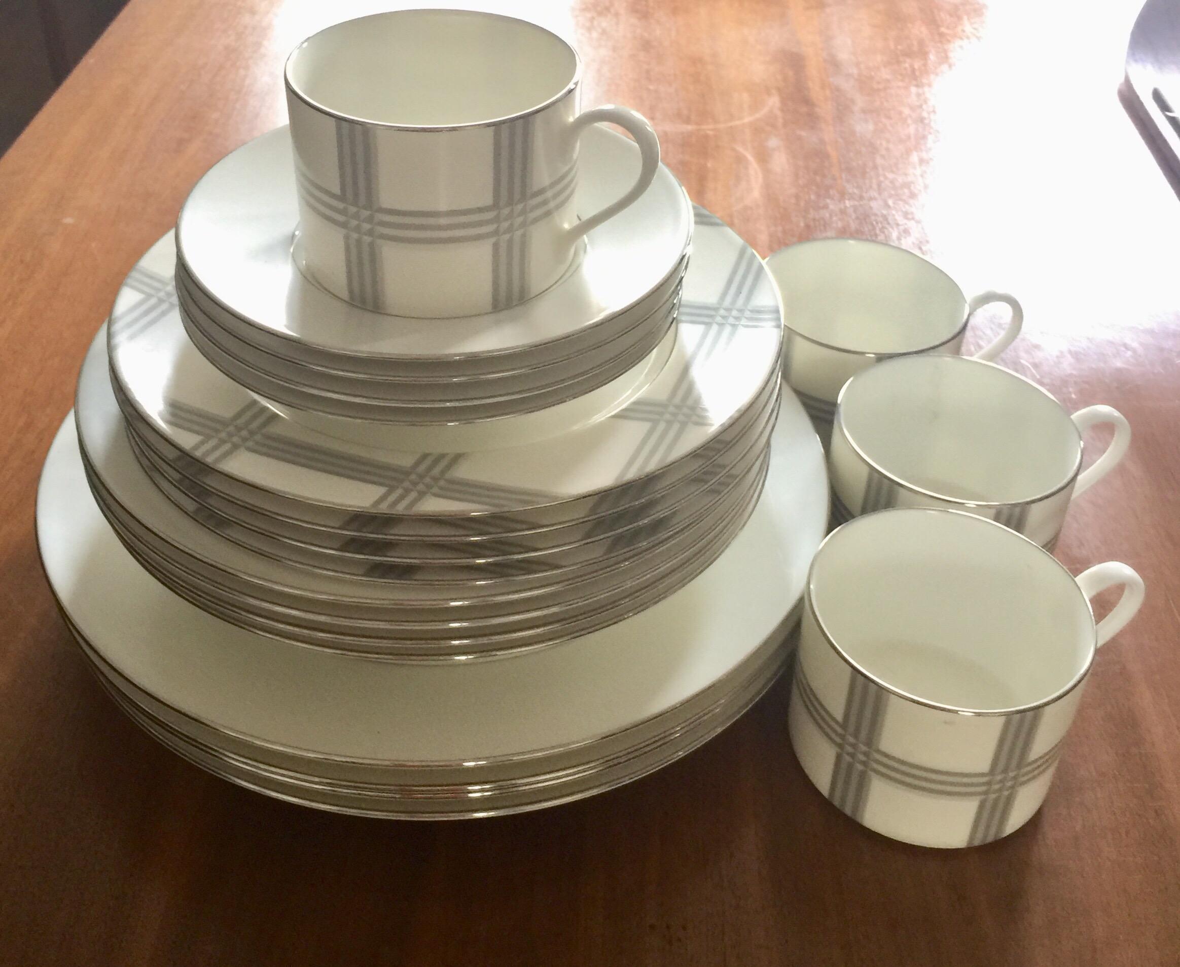 A set of 4 (four) place settings in the Glen Plaid pattern by Ralph Lauren. Signed. Imported, circa 2010.

White with beige pattern.

Fine porcelain.

A total of 20 total pieces. 

Each setting includes the following 5 (five) pieces: Dinner
