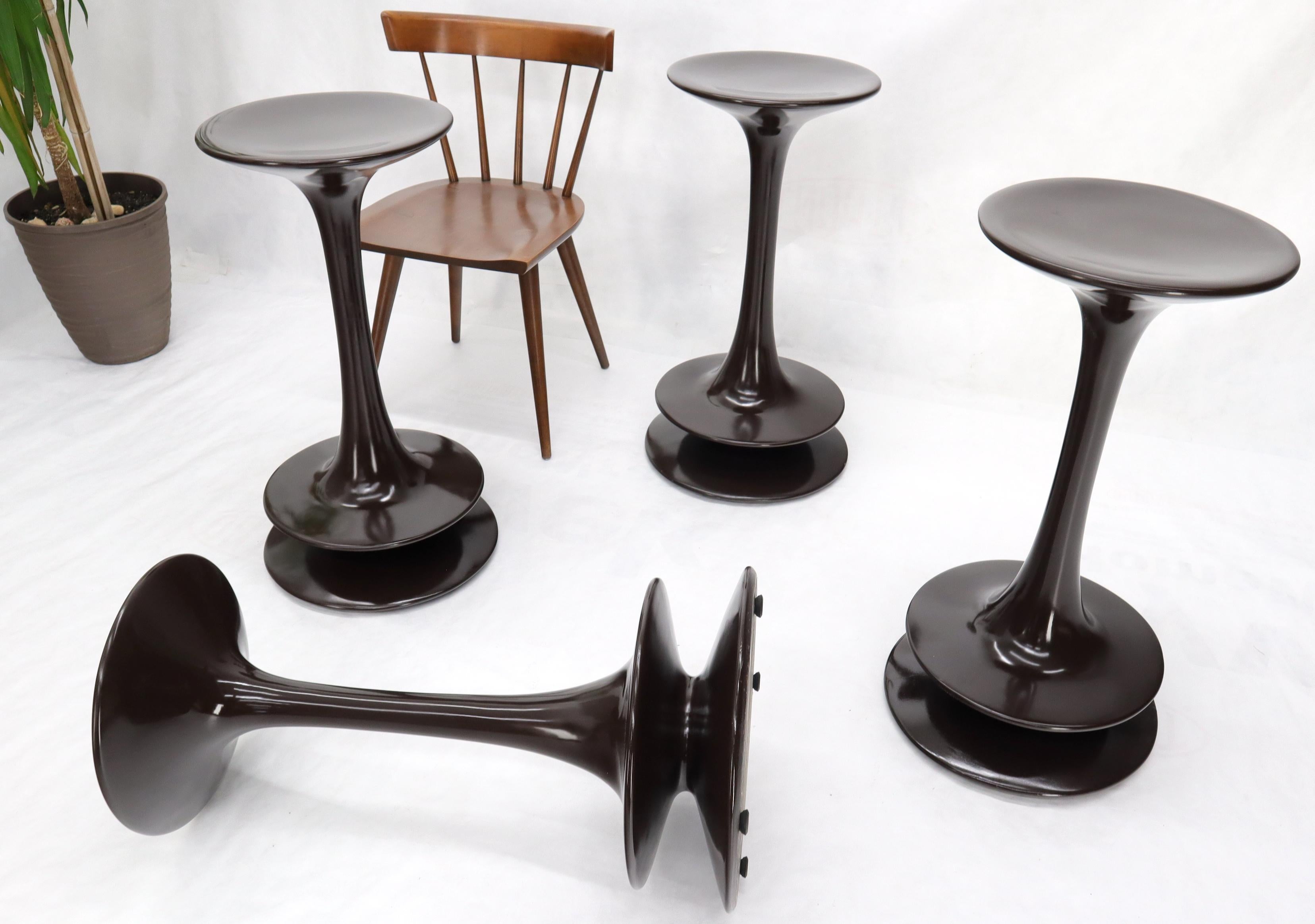 Set of unique studio made polished composite weighted bottoms round bar stools.