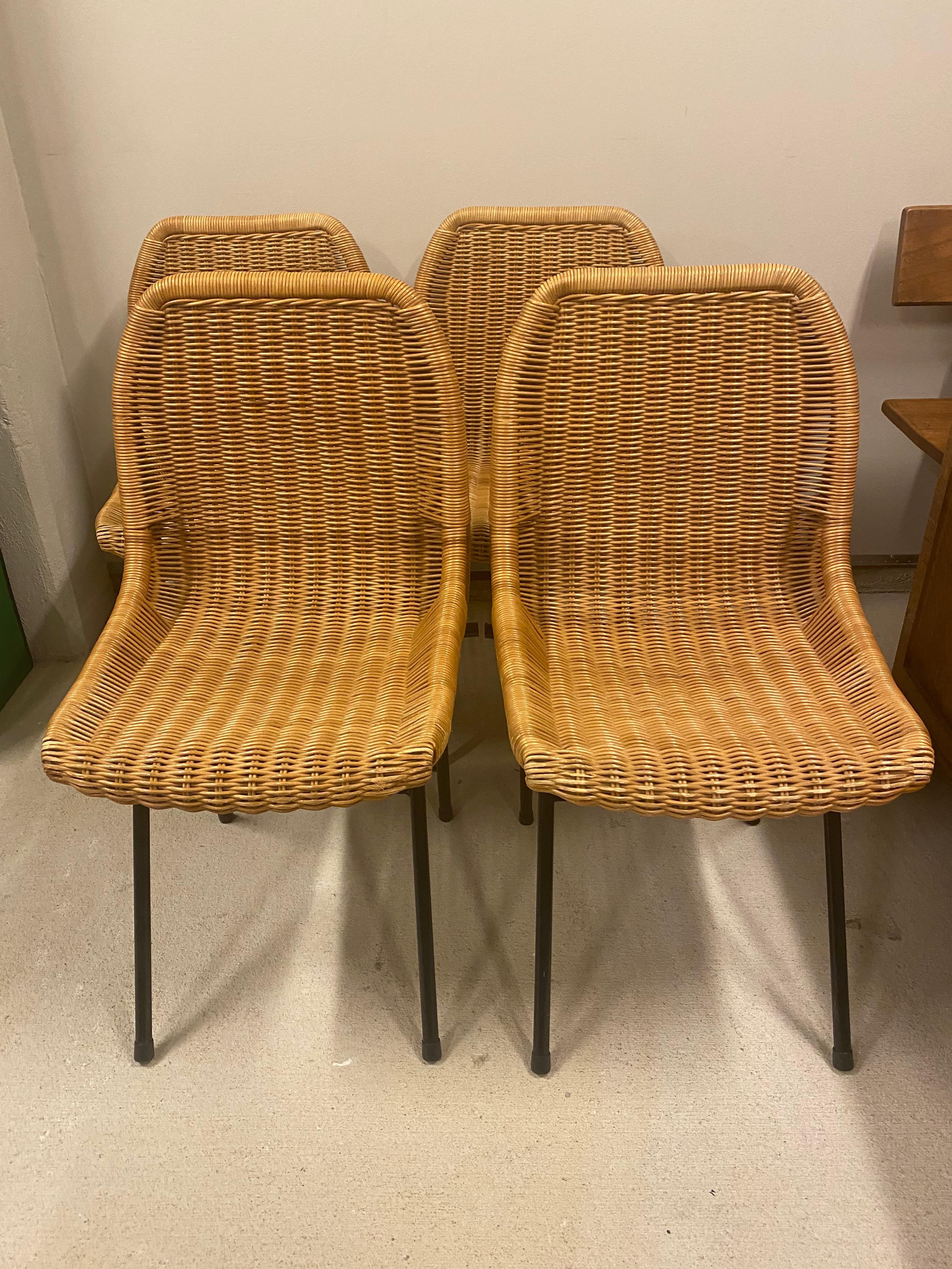 Charming and comfortable set of woven wicker or rattan dining or side chairs on powder coated black steel frames, by Dirk van Sliedregt (also spelled Sliedrecht.) The Netherlands, 1960's. 

Sold as a set of 4. Additional pair of chairs available and