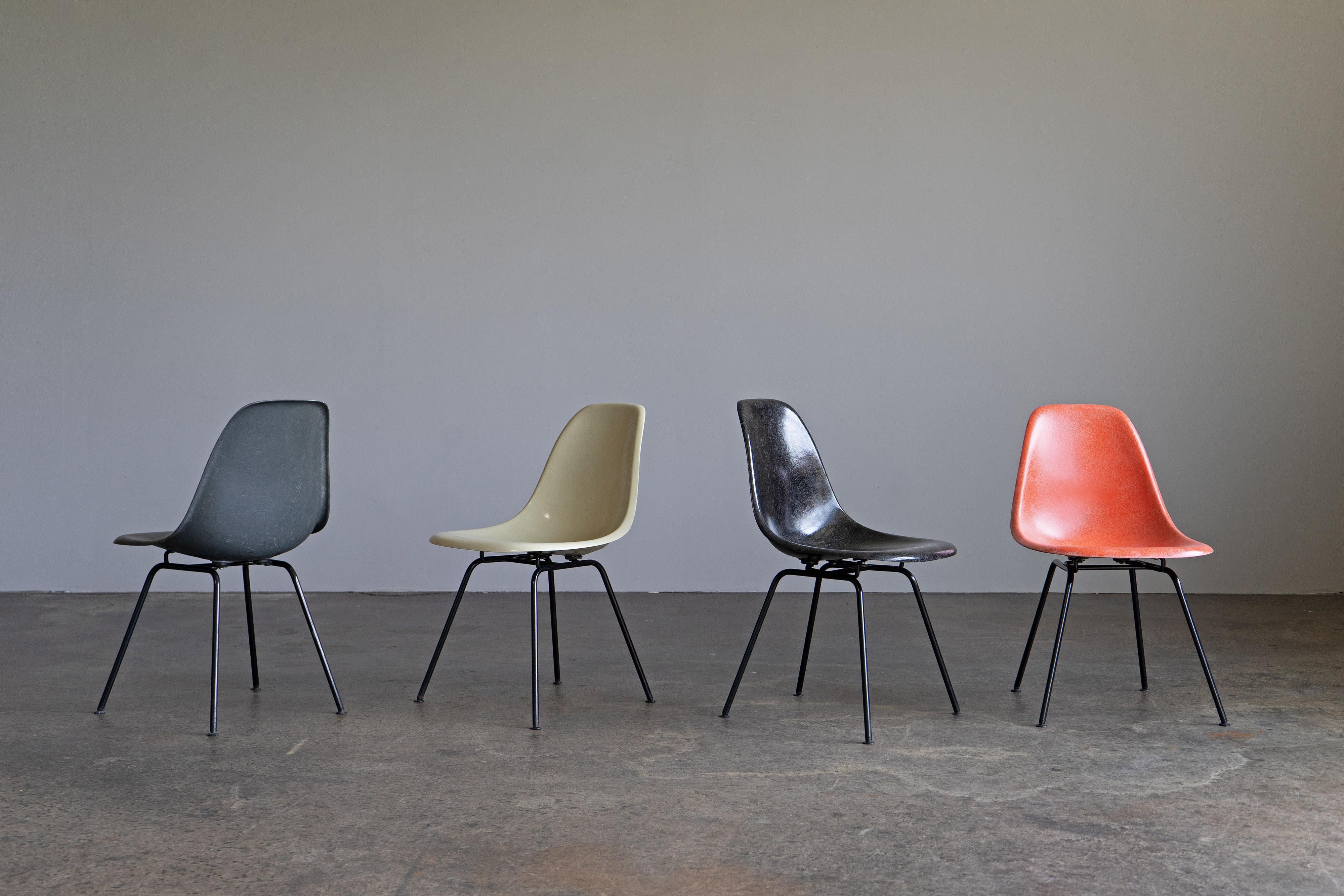 Set of four multicoloured side chairs by Charles and Ray Eames. The chairs have been produced by Herman Miller/Vitra in the 1960s and show a beautiful fiberglass structure. The shells are mounted on H-bases.