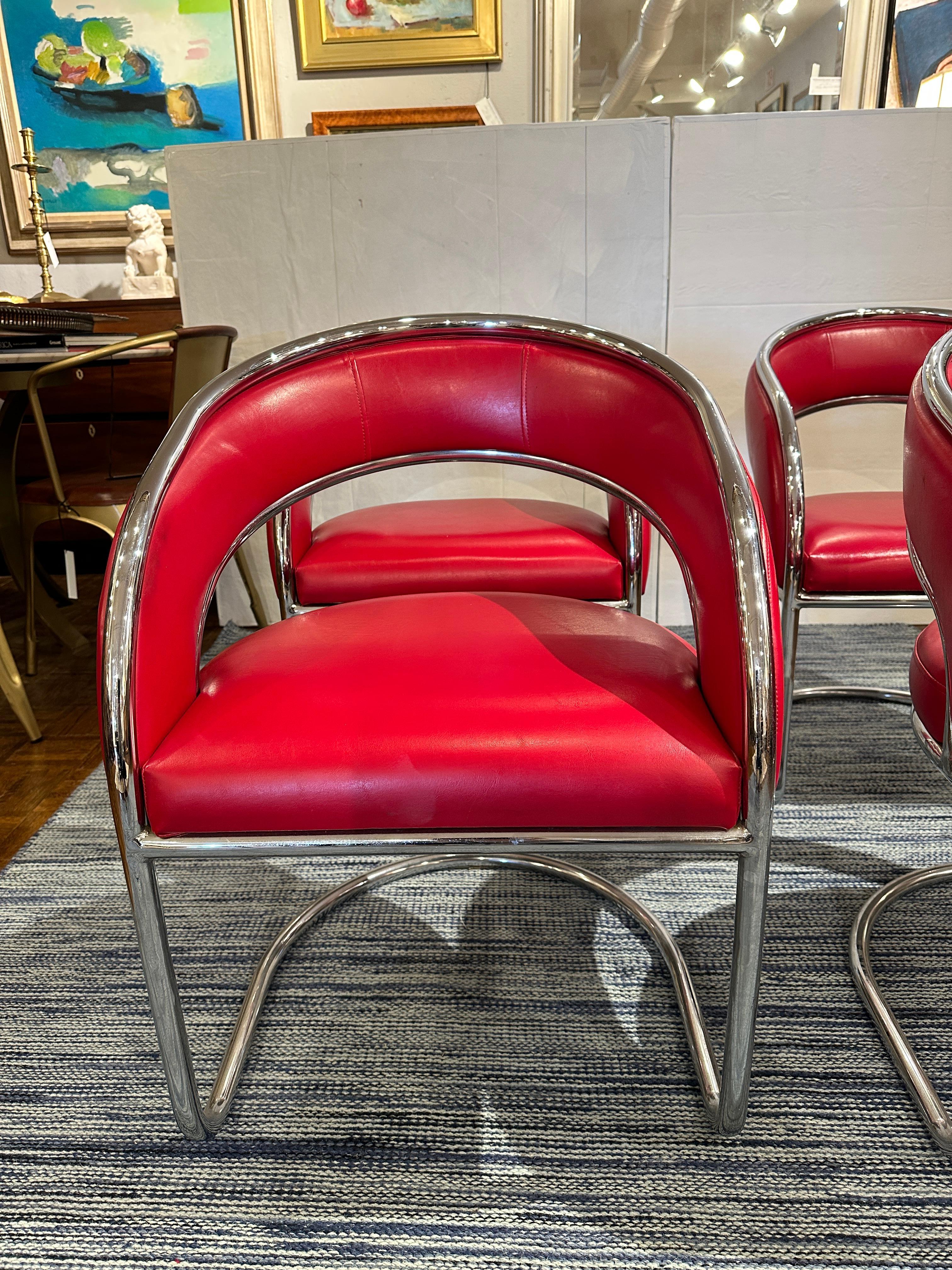 Set of 4.  Mid Century Modern chairs from 1960s.  Upholstered in Bright cheerful red  leather, framed in shiny chrome.  Very comfortable as lounging or game table chairs.  In great condition.