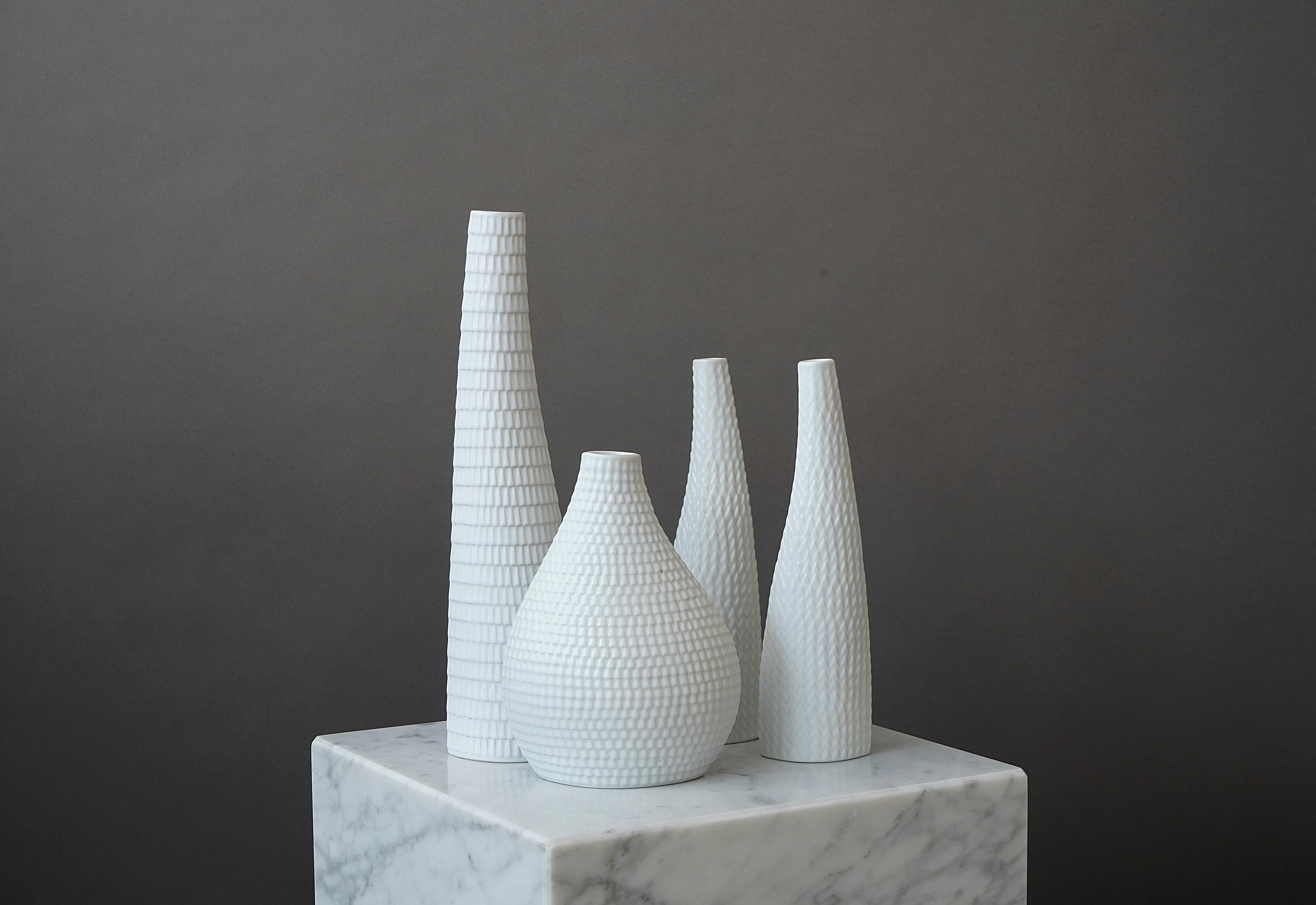 Set of 4 beautiful 'Reptil' vases.
Made by Stig Lindberg in Gustavsberg Studio, Sweden. 1953.

Excellent condition.
Impressed Gustavsberg studio hand.

Stig Lindberg (1916-1982) was a Swedish ceramic designer, glass designer, textile designer,